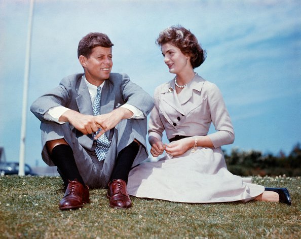 John F. Kennedy and Jaqueline Kennedy sitting in the grass | Photo: Getty Images