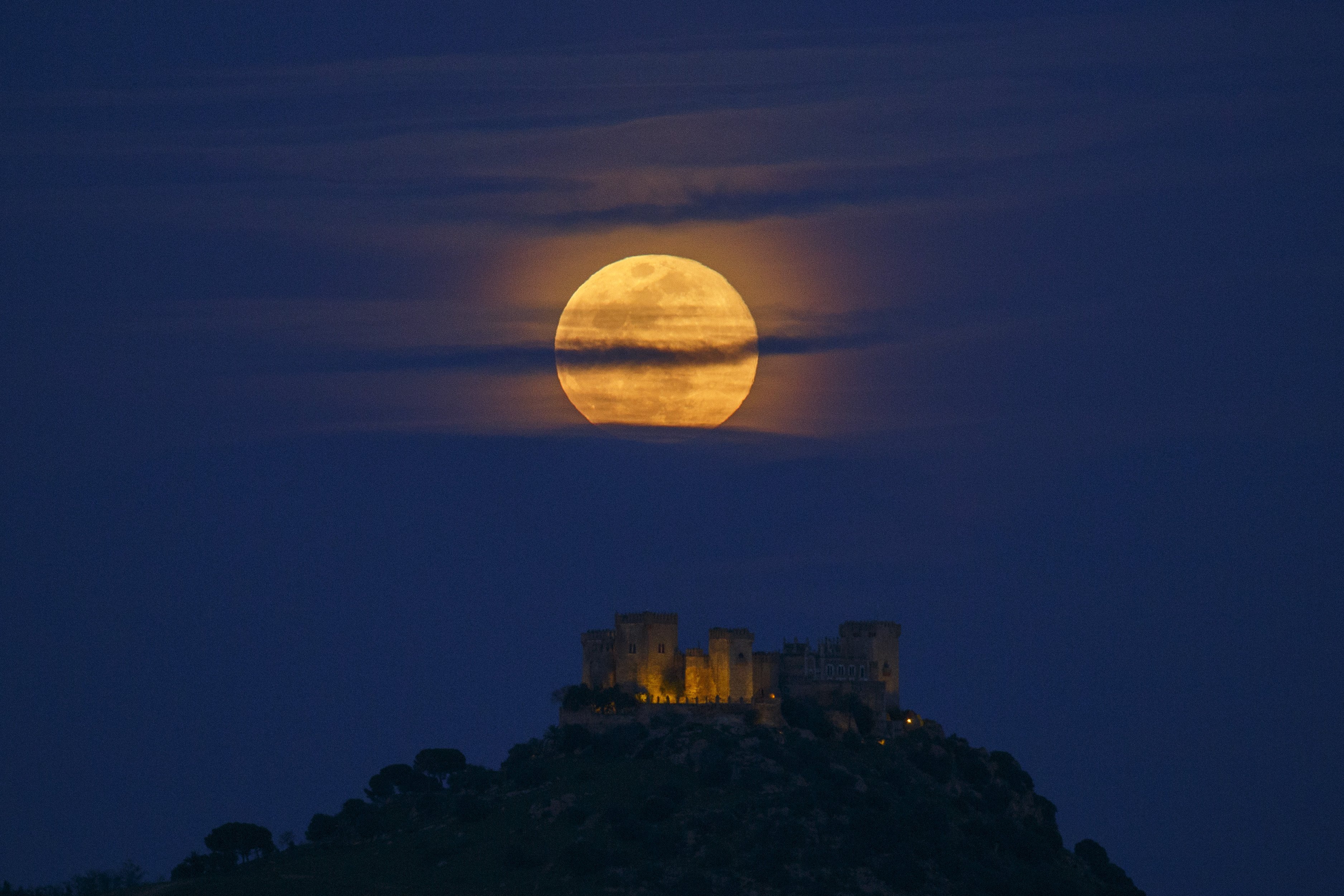 A full moon rises over Almodovar del Rio Castle on March 31, 2018 in Almodovar del Rio, Cordoba province, Spain | Source: Getty Images