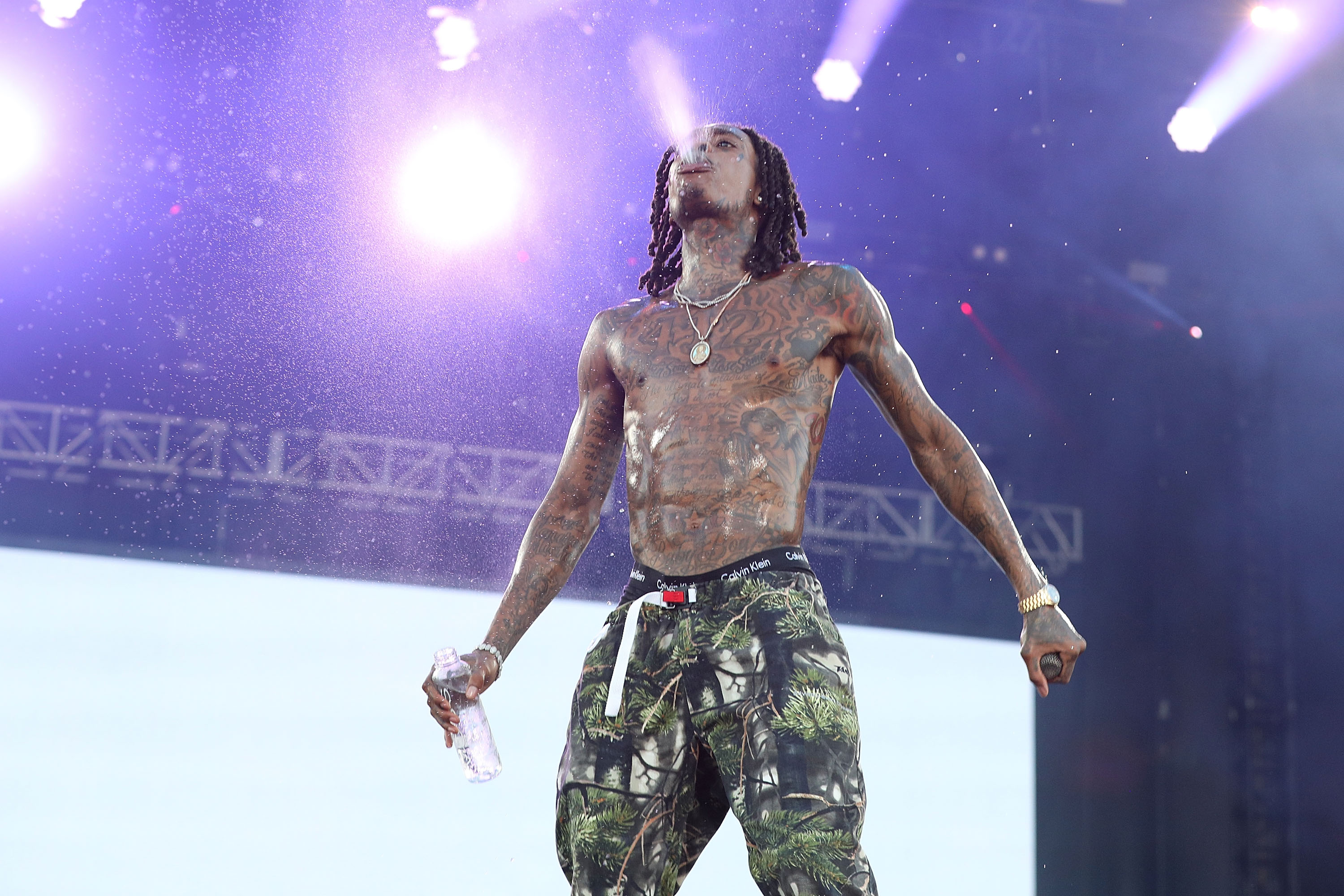 Wiz Khalifa's MMA-inspired transformation was on full display as he performed during the 2018 KAABOO Del Mar Festival at the Del Mar Fairgrounds in Del Mar, California, on September 16, 2018. Shirtless on stage, the rapper showcased a noticeably more muscular chest, arms, and shoulders compared to the lean build that defined his earlier years.