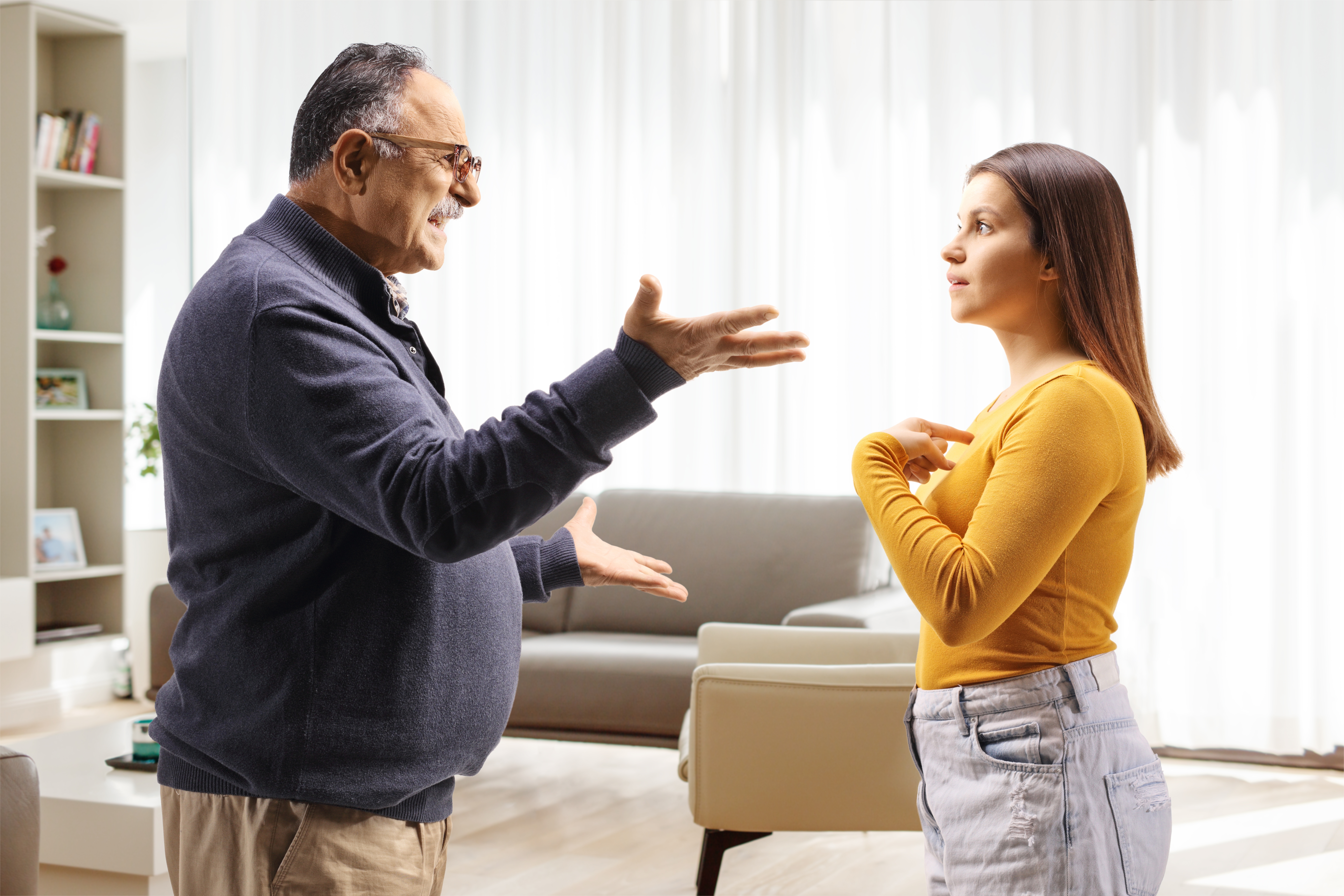 An older man having a heated discussion with his daughter | Source: Shutterstock