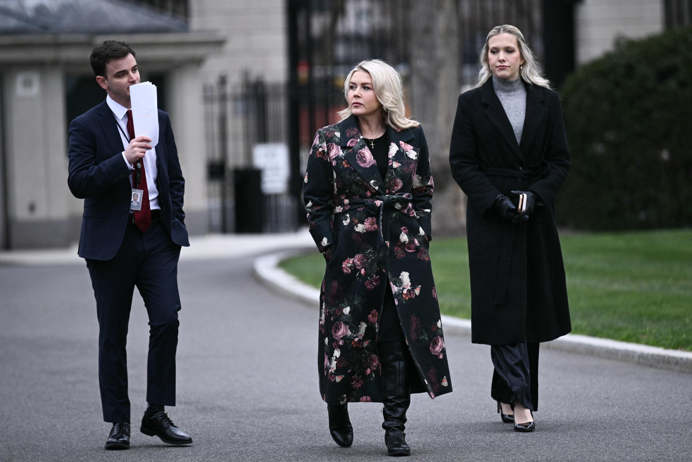 Karoline Leavitt walks with colleagues outside the White House before speaking to reporters in Washington, DC. | Source: Getty Images