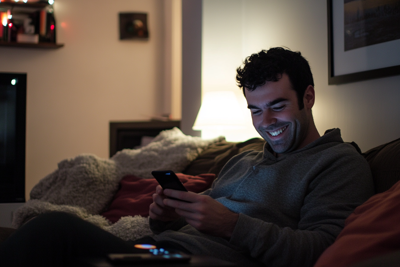 A man smiling while texting | Source: Midjourney