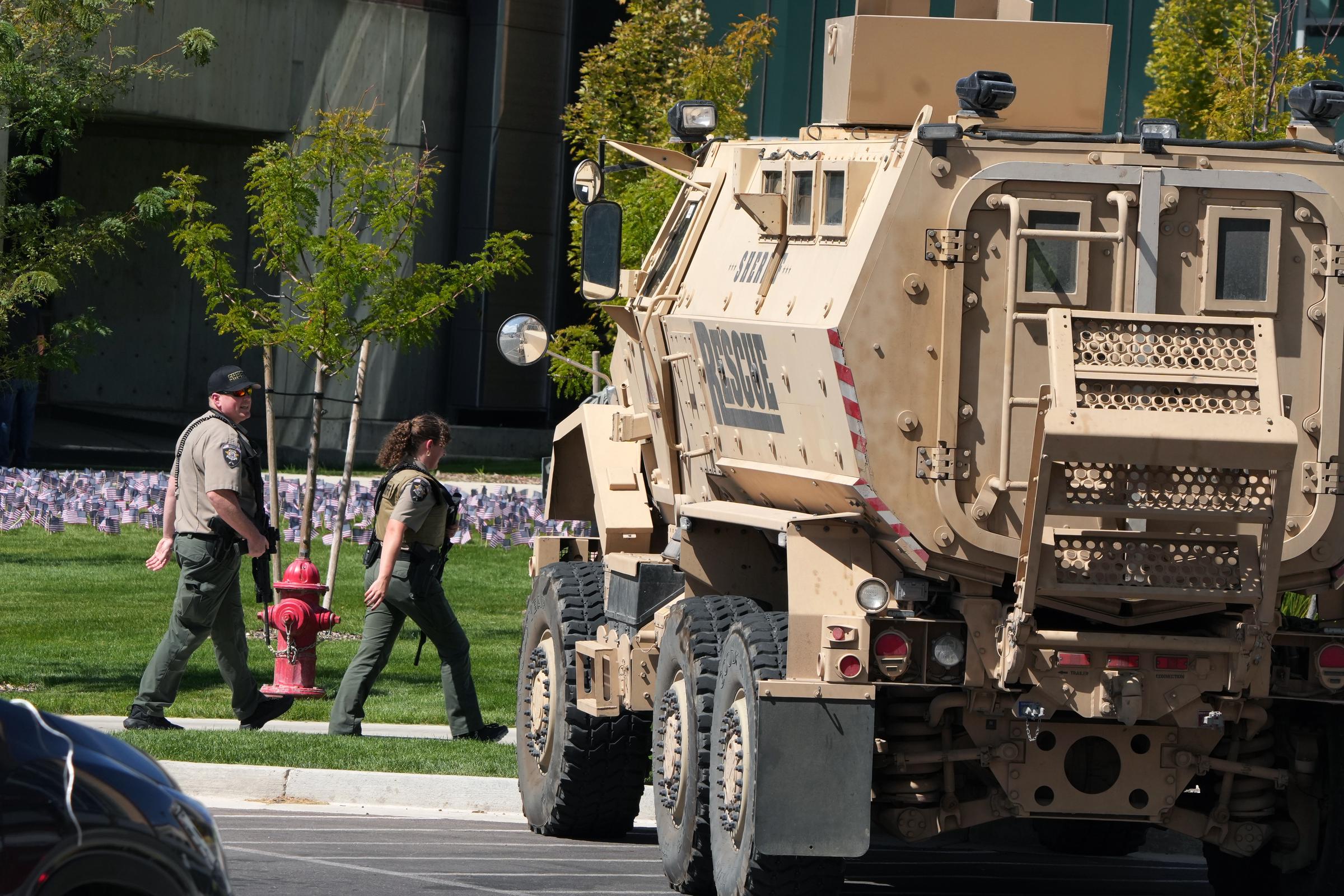 Officers walk past an armored vehicle as law enforcement responds to the shooting at Utah Valley University on September 10, 2025 | Source: Getty Images