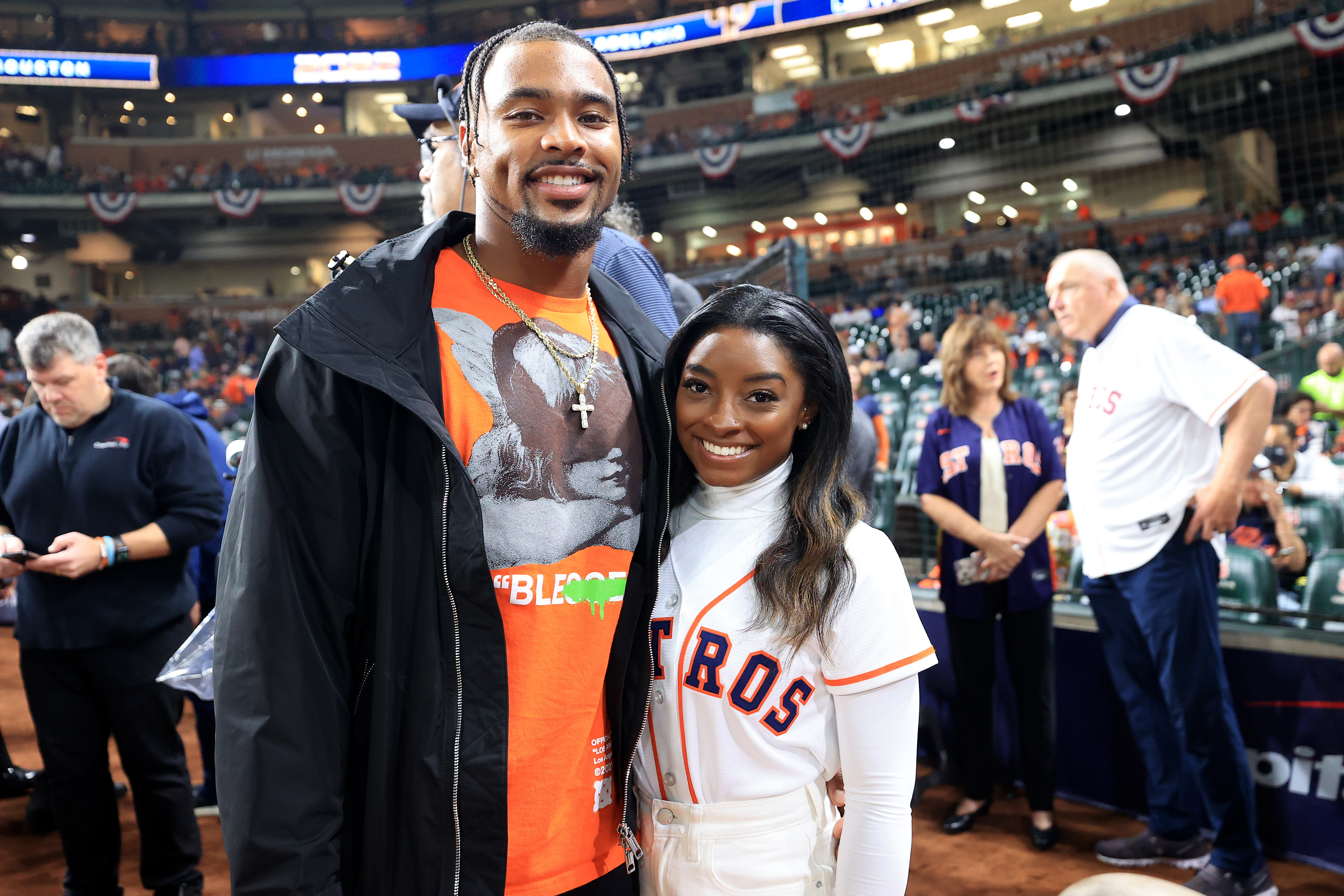 Jonathan Owens and Simone Biles pose on the field before Game One of the 2022 World Series on October 28, 2022, in Houston, Texas | Source: Getty Images