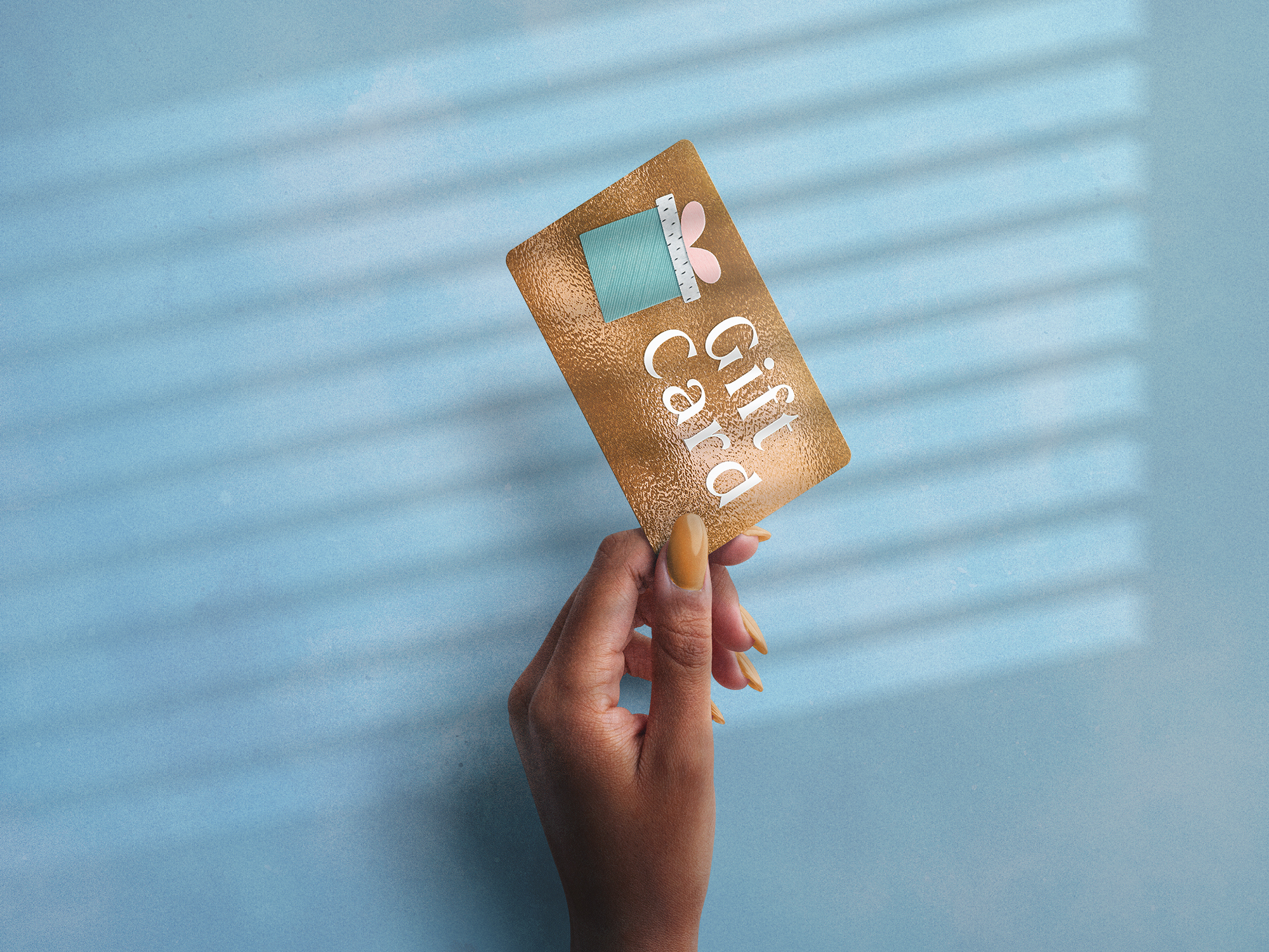A woman holding up a gift card | Source: Getty Images