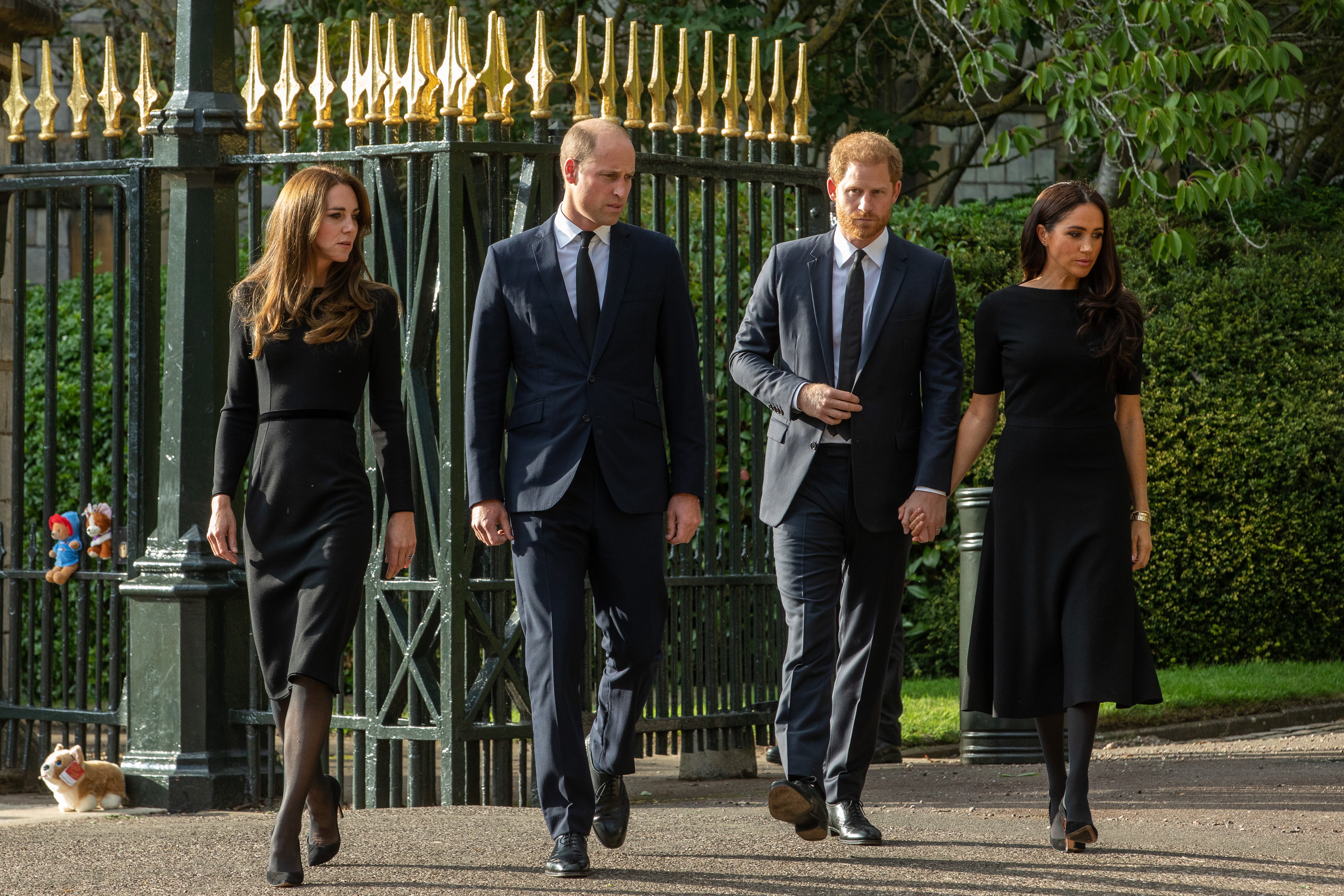 Prince William and Catherine, the new Prince and Princess of Wales, accompanied by Prince Harry and Meghan, the Duke and Duchess of Sussex, arrive to view floral tributes to Queen Elizabeth II laid outside Cambridge Gate at Windsor Castle on 10th September 2022 in Windsor, United Kingdom | Source: Getty Images
