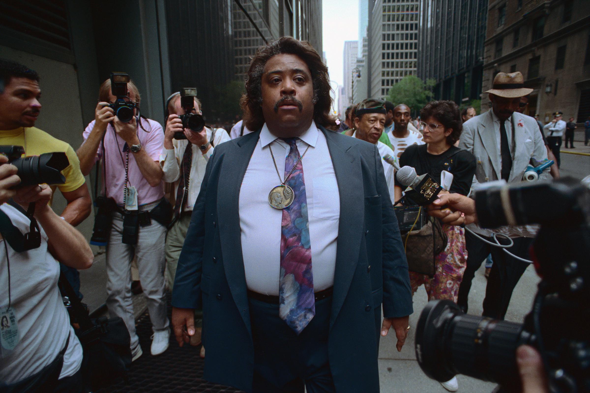 Reverend Al Sharpton photographed walking with news media in 1992. | Source: Getty Images
