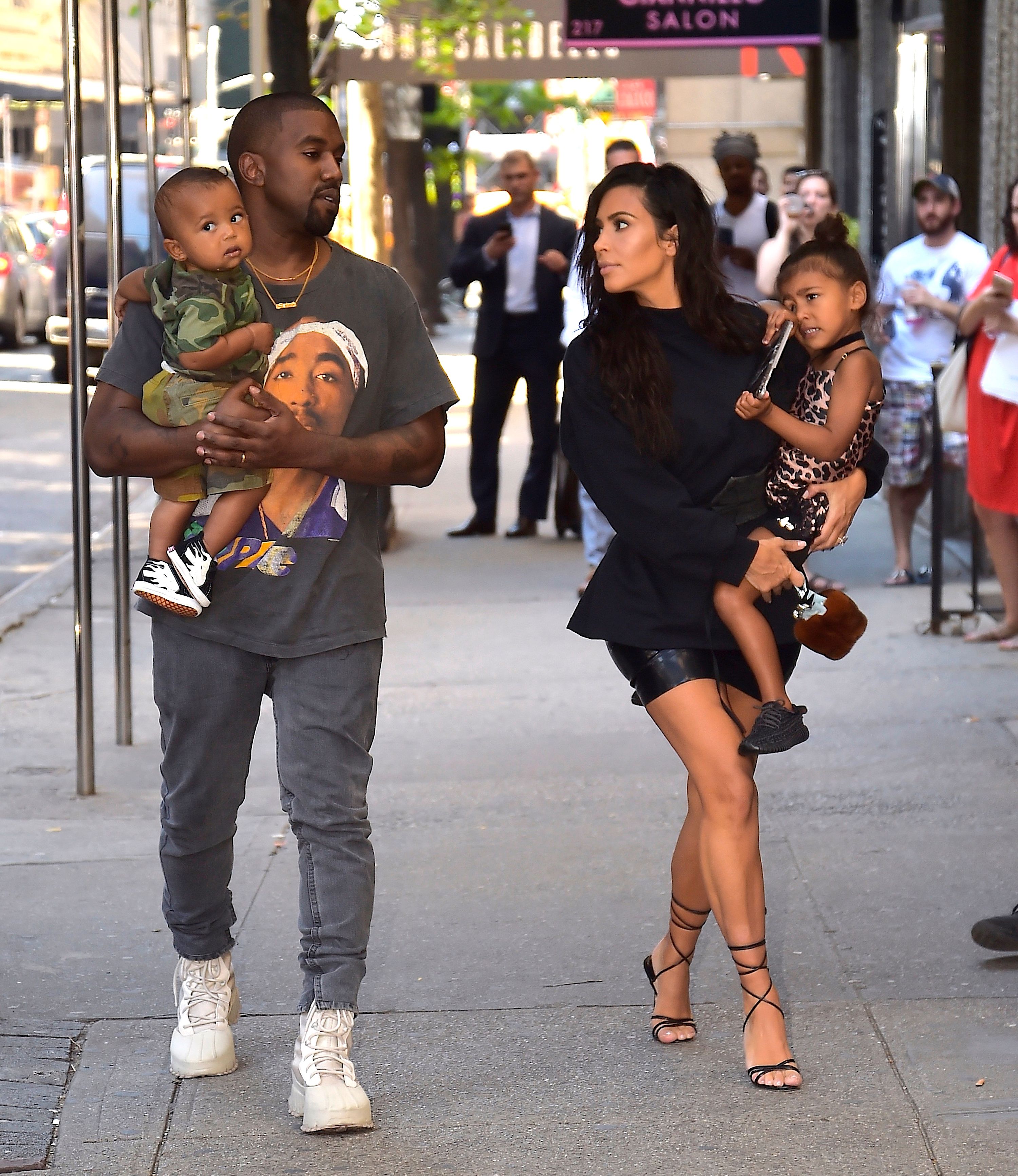 Kanye West and Kim Kardashian with North West and Saint West walking in the Upper East Side on August 29, 2016 | Photo: Getty Images