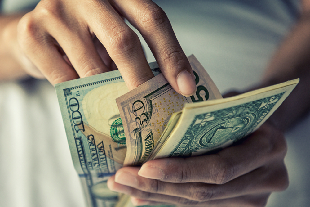 Close-up of a person holding money | Source: Shutterstock