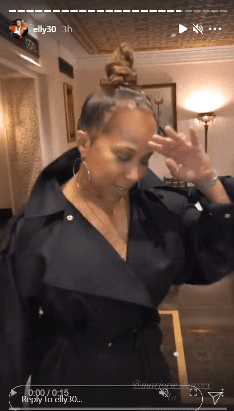 An image from a clip of Marjorie Harvey dressed in a black belted coat | Photo: Instagram/elly30
