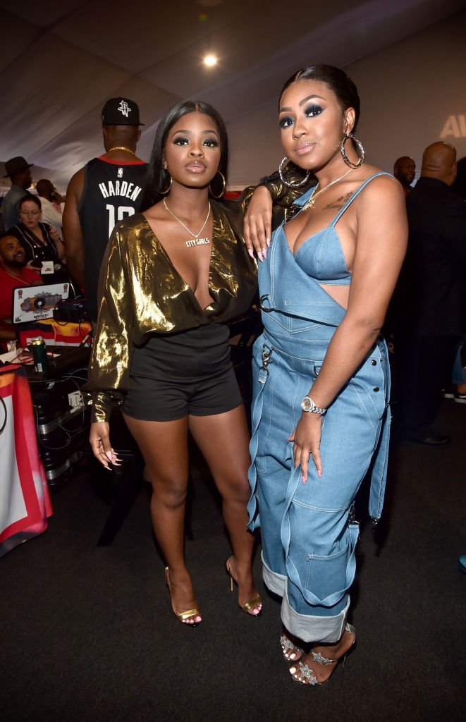 Yung Miami (L) and J.T. of musical group City Girls attend day one of the 2018 BET Awards Radio Remotes | Photo: Getty Images