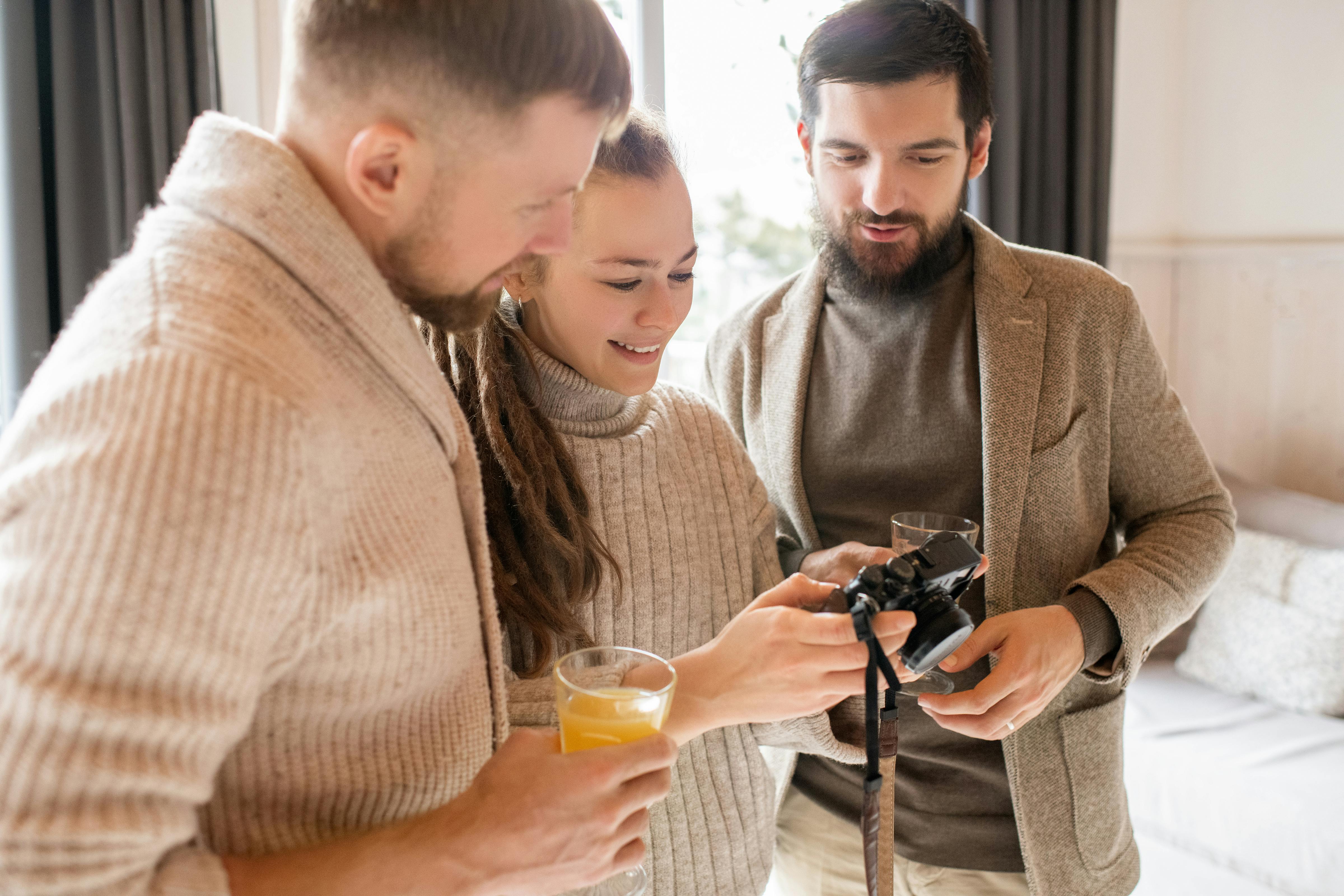 A photo of three people looking at a camera | Source: Pexels
