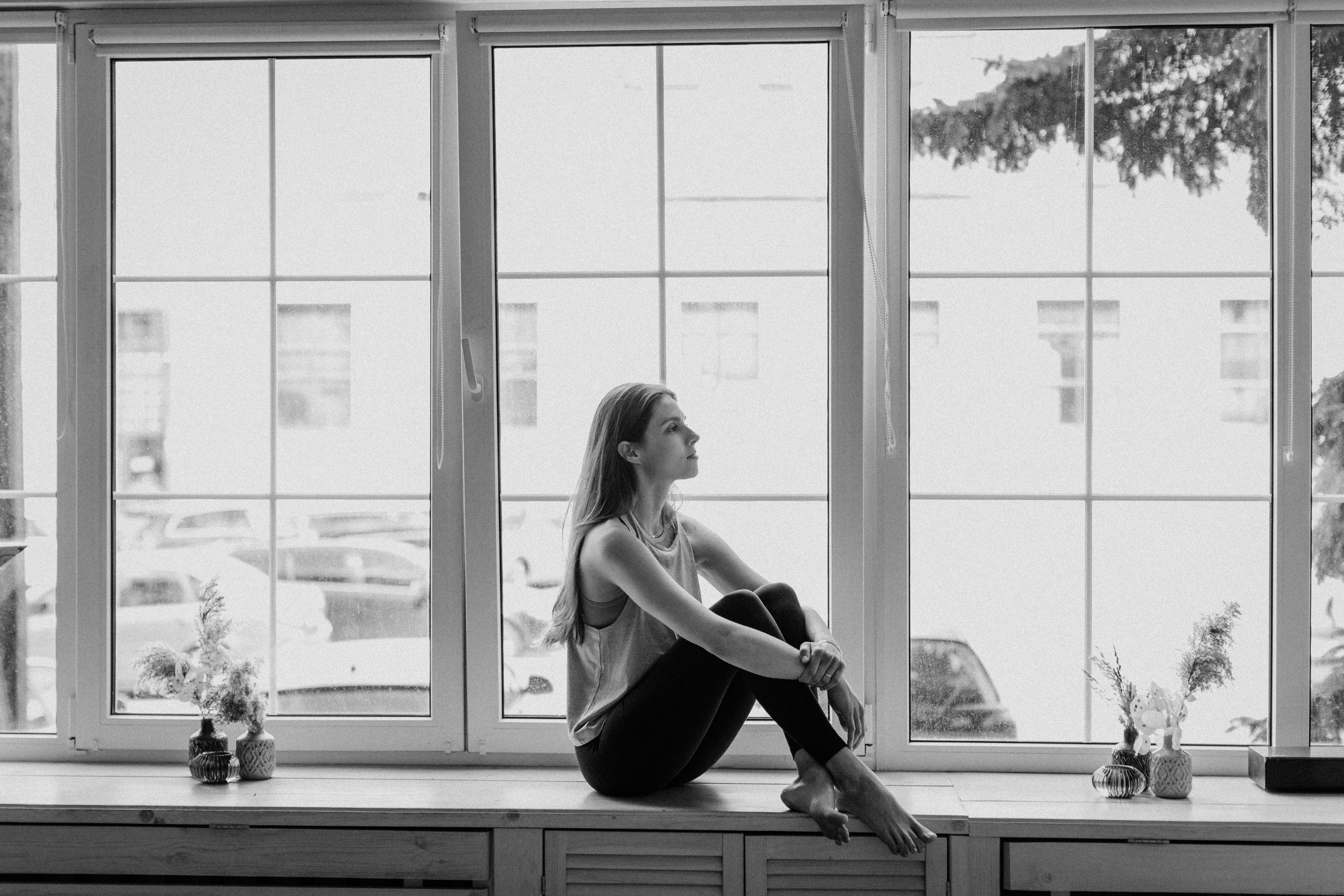 A woman sitting on the windowsill | Source: Pexels