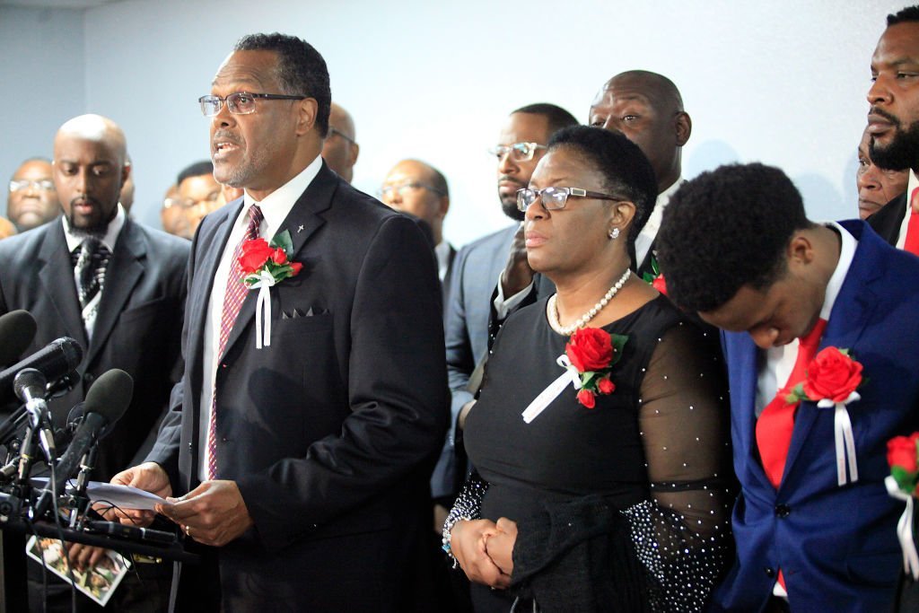 Sammie L. Berry speaks as church members stand with the family of Botham Shem Jean at Greenville Avenue Church of Christ after the funeral service | Photo: Getty Images