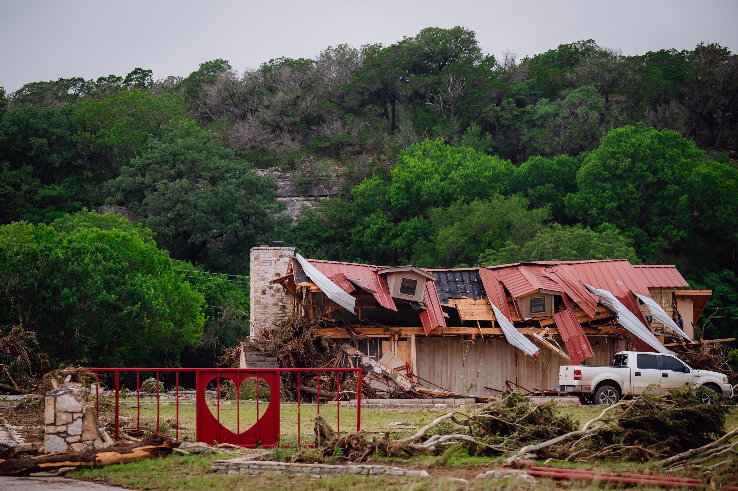 Flood damage around a two-story building in Kerr County, Texas on July 5, 2025. | Source: Getty Images