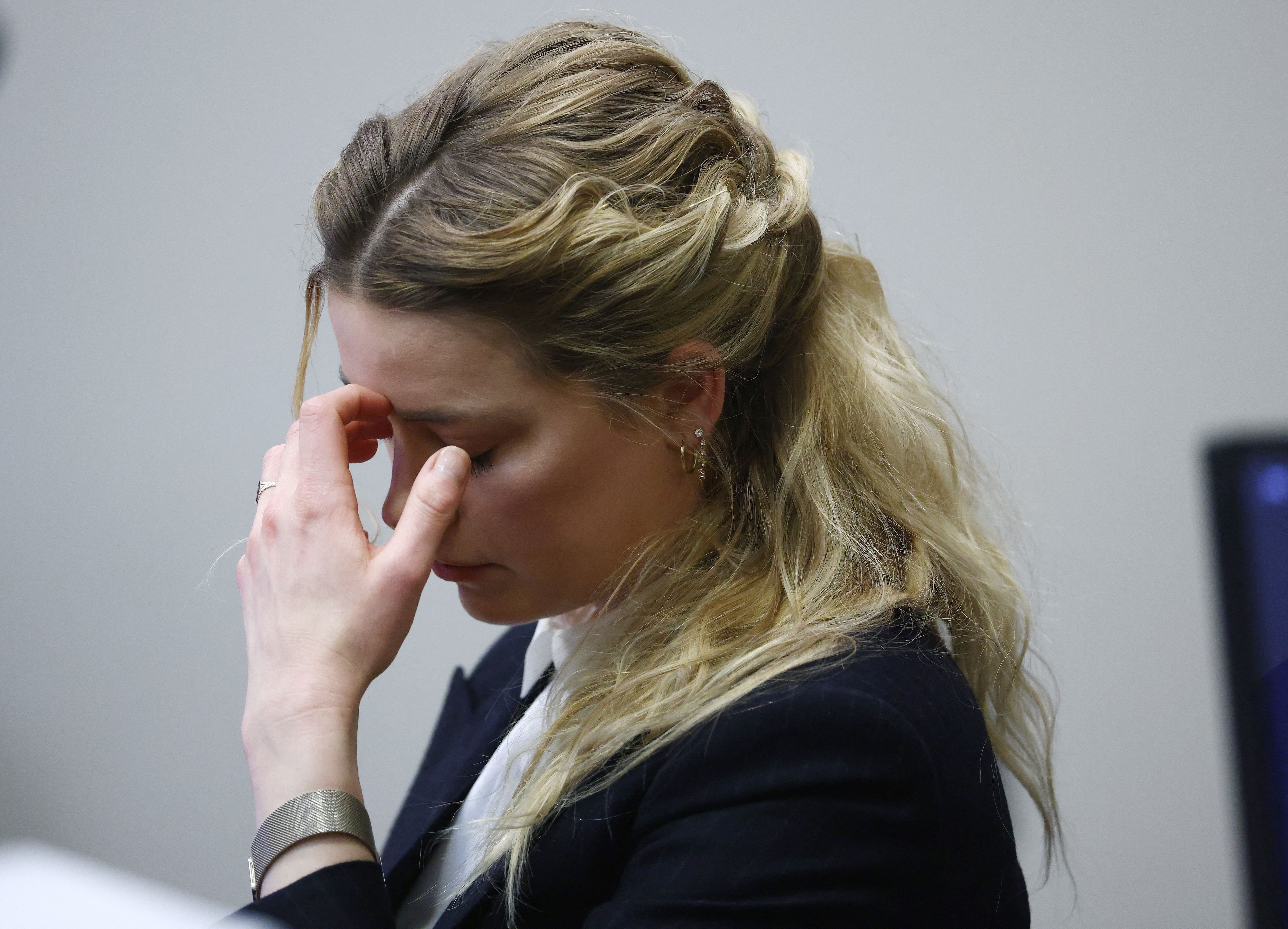 Amber Heard while listening to an audio recording of her and Johhny Depp arguing during the Depp vs Heard $50 million defamation trial at the Fairfax County Circuit Court in Fairfax, Virginia, April 21, 2022. | Source: Getty Images