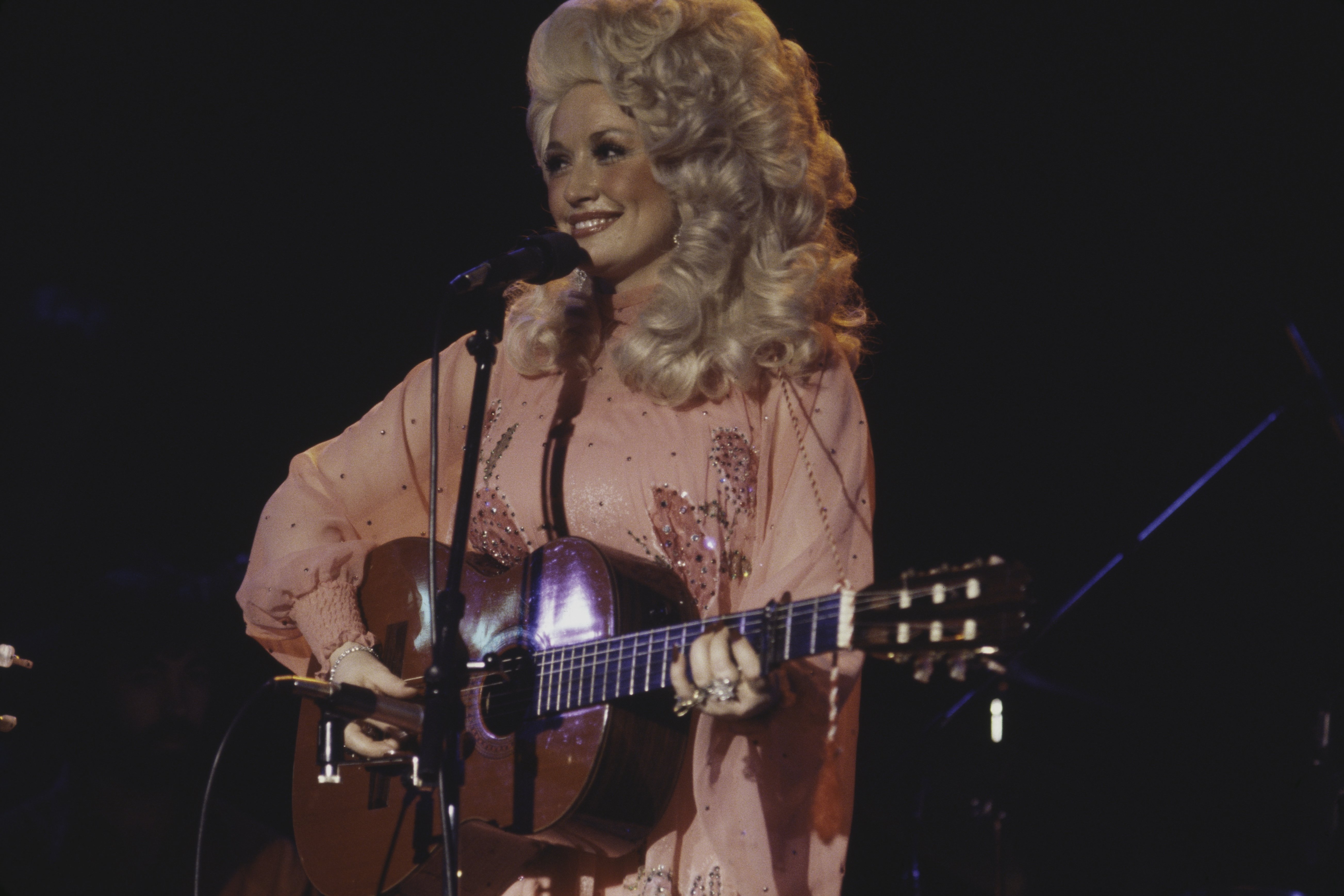 Dolly Parton performs live on stage at the Bottom Line club in New York on 11th May 1977 | Photo: GettyImages