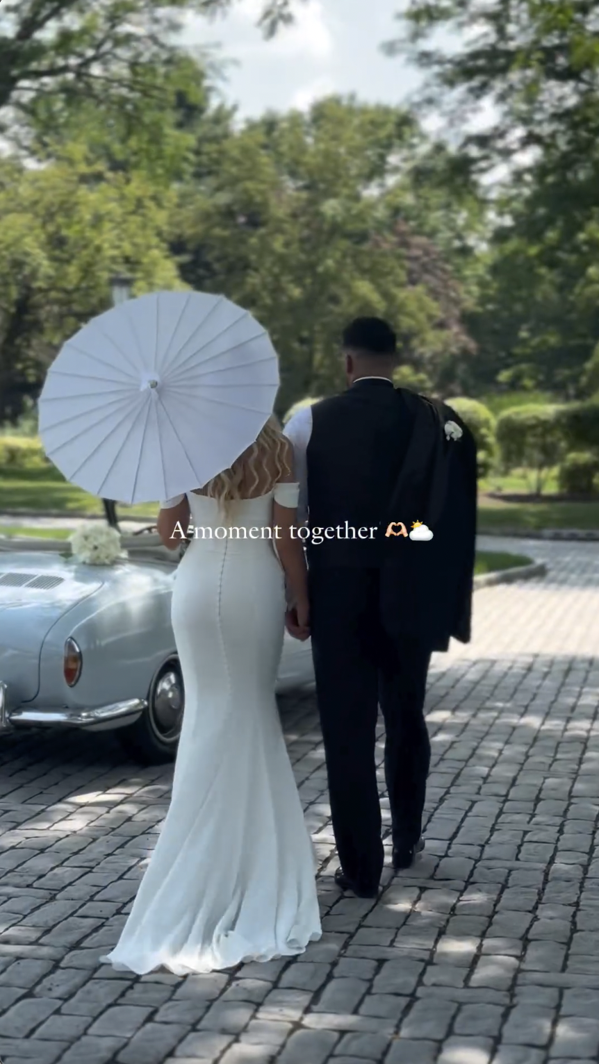 Victoria Schultz and Jon Runyan Jr. posing by a vintage car on their wedding day, posted on July 10, 2024 | Source: Instagram/antpagephoto, alenkafilms and victoriajrunyan