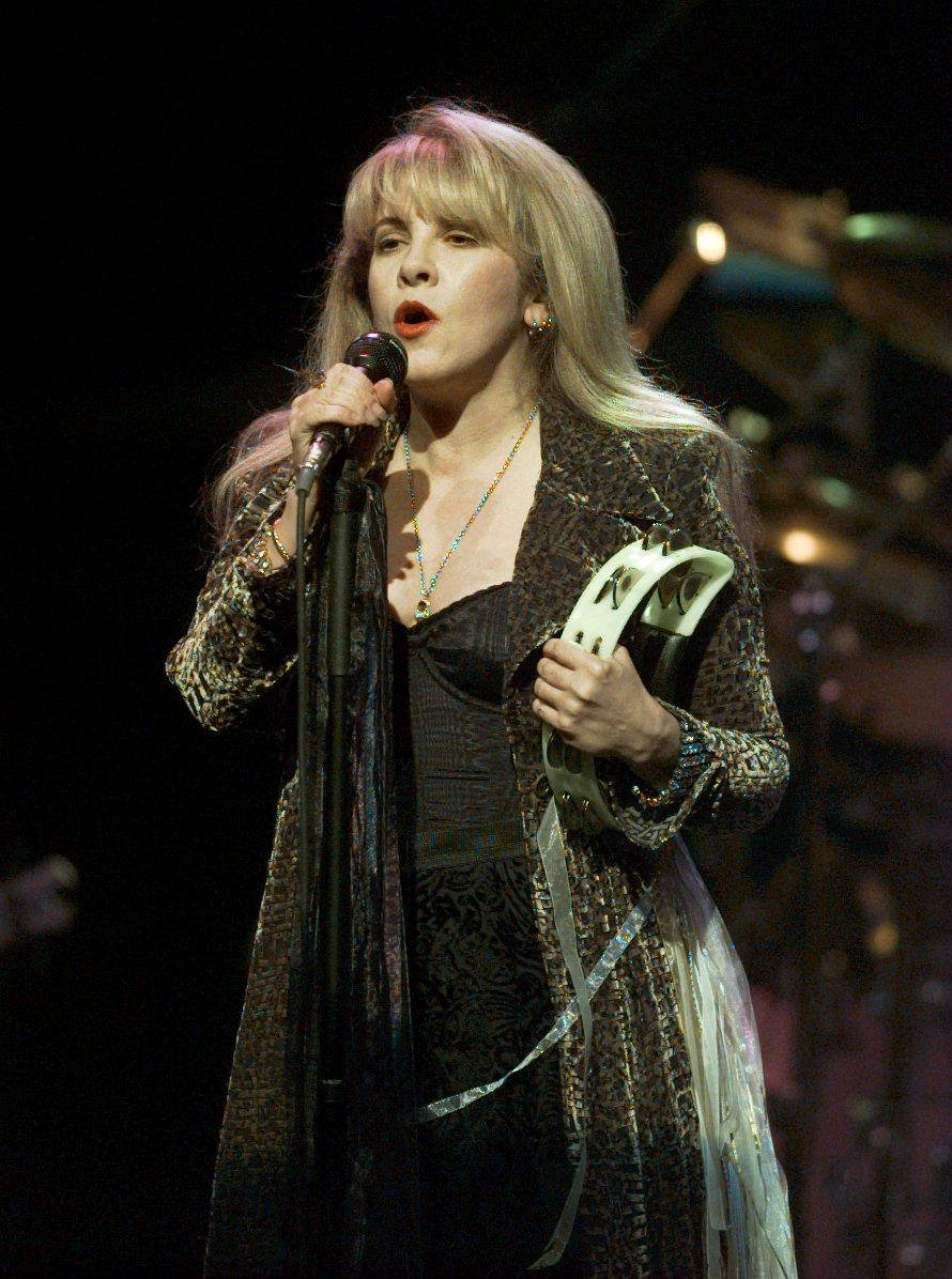 The artist sings while holding a tambourine during the Fleetwood Mac concert at the Nassau Coliseum in Uniondale on September 23, 1997 in New York. | SOurce: Getty Images