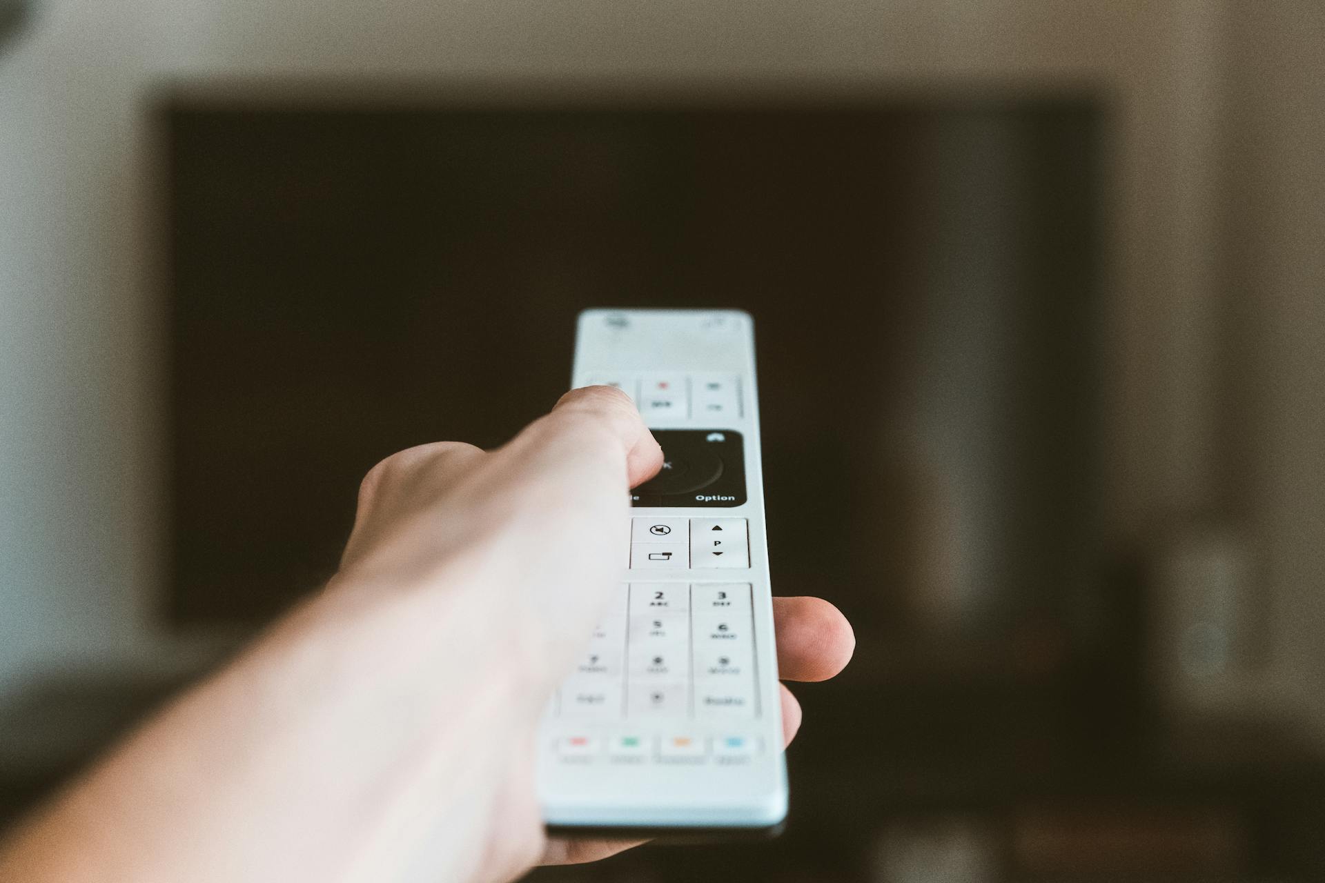 A man switching TV channels | Source: Pexels