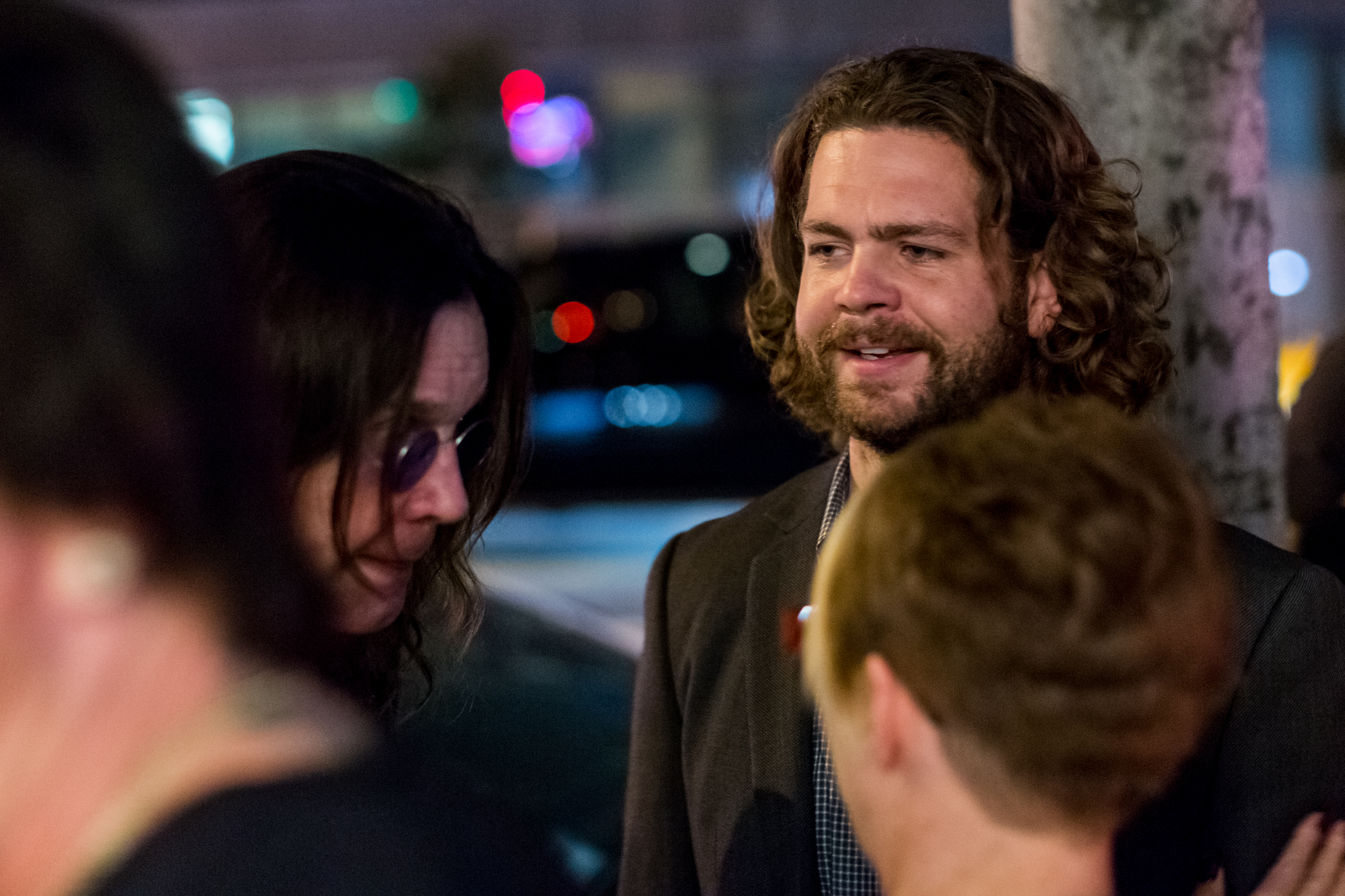 Ozzy Osbourne and his son Jack are pictured together at the opening of "Social Distortion: A Capsule Collection of Fine Art" by Billy Morrison in West Hollywood on 29 October 2016, the singer wearing tinted glasses as Jack speaks with guests nearby.