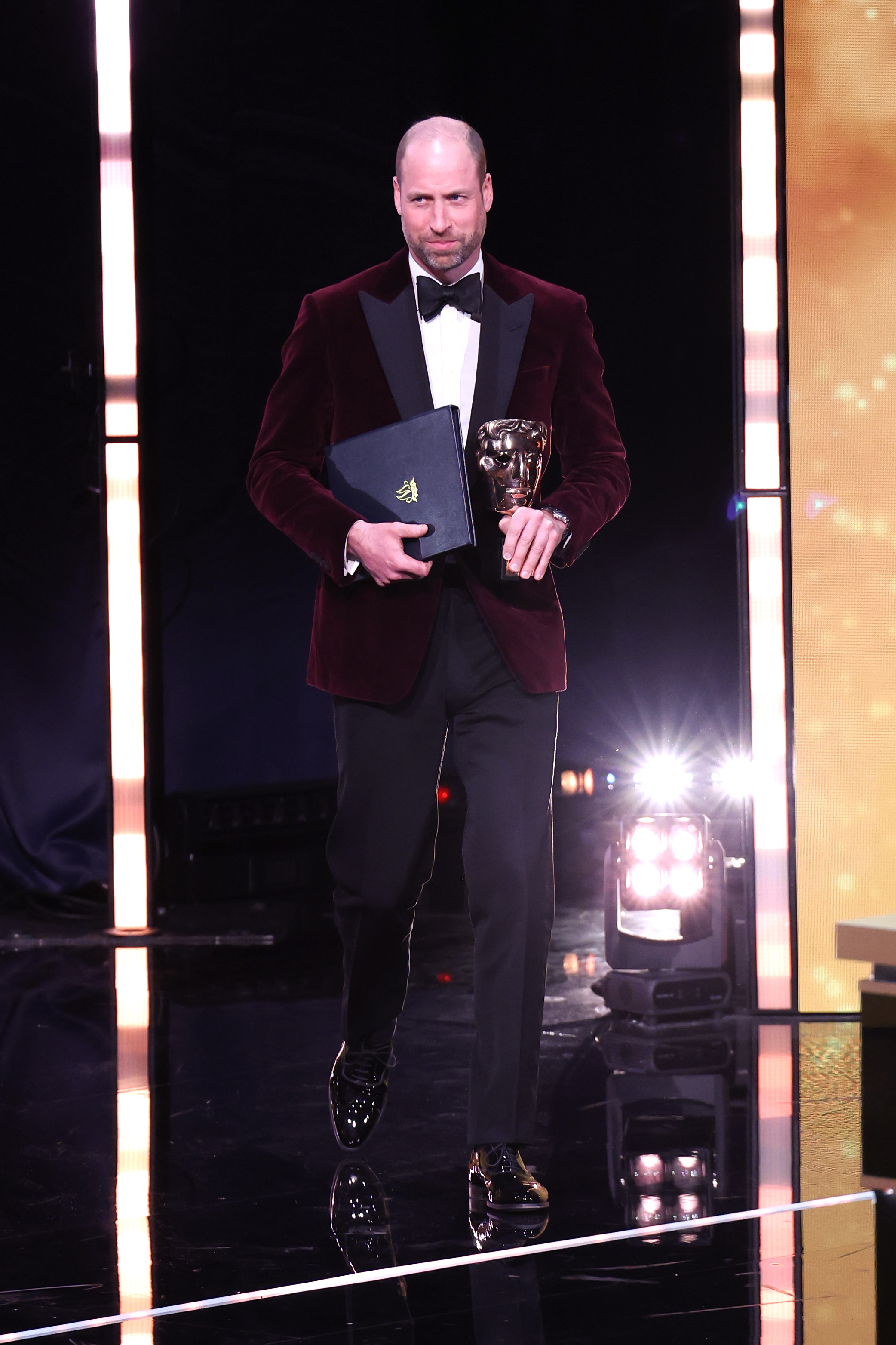 Under bright stage lights at the Royal Festival Hall, the Prince of Wales stepped forward to present the BAFTA Fellowship during the film awards, holding the iconic bronze mask. Dressed in his maroon velvet blazer and black tie, he cut a composed figure as he fulfilled his role as President of the BAFTAs on February 22 in London, England.