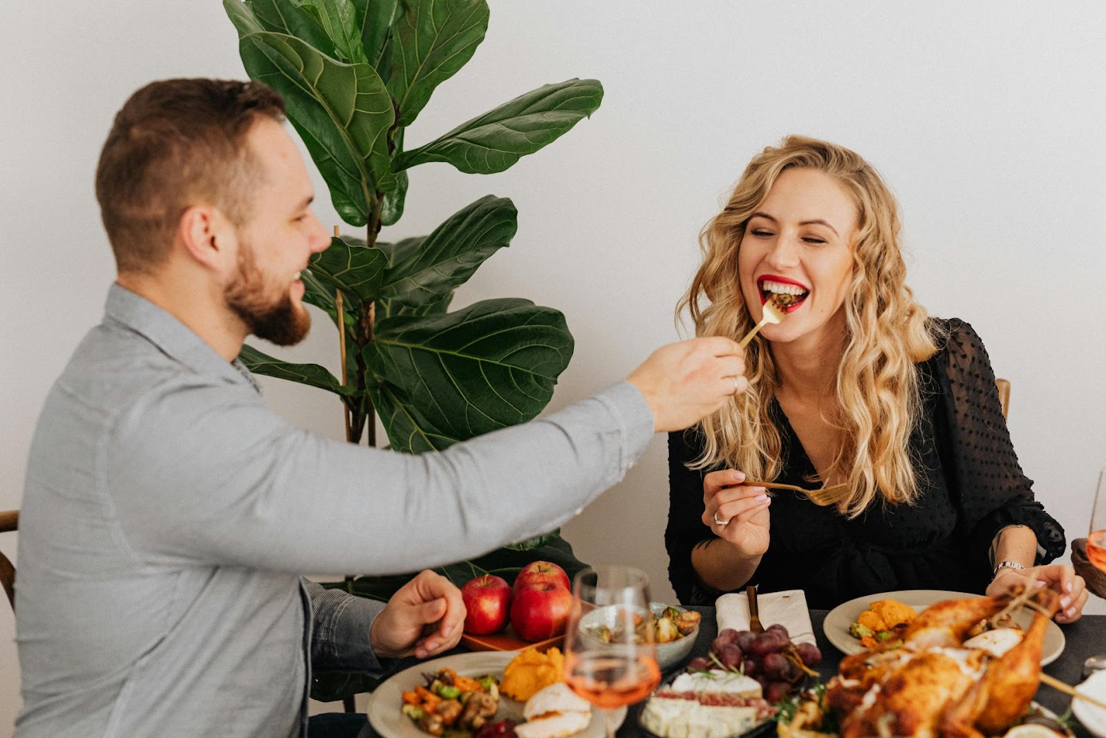 A husband feeding his wife during a homemade dinner | Source: Pexels