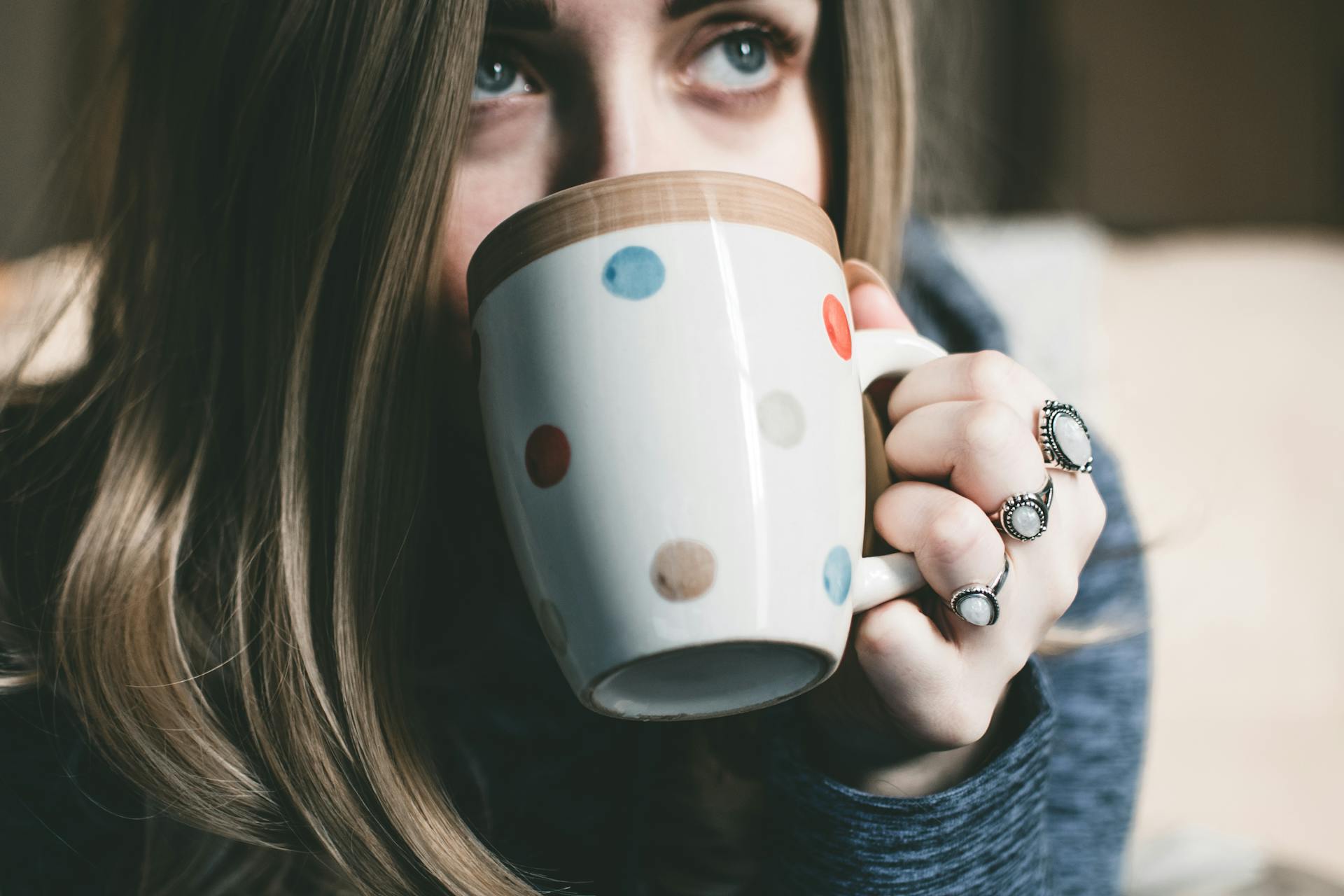 A woman drinking from a mug | Source: Pexels