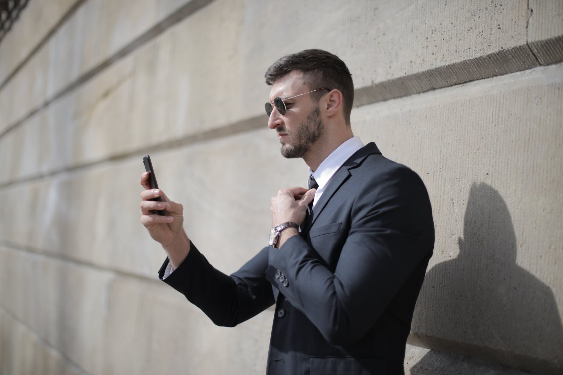 Man in a suit with his phone | Source: Pexels
