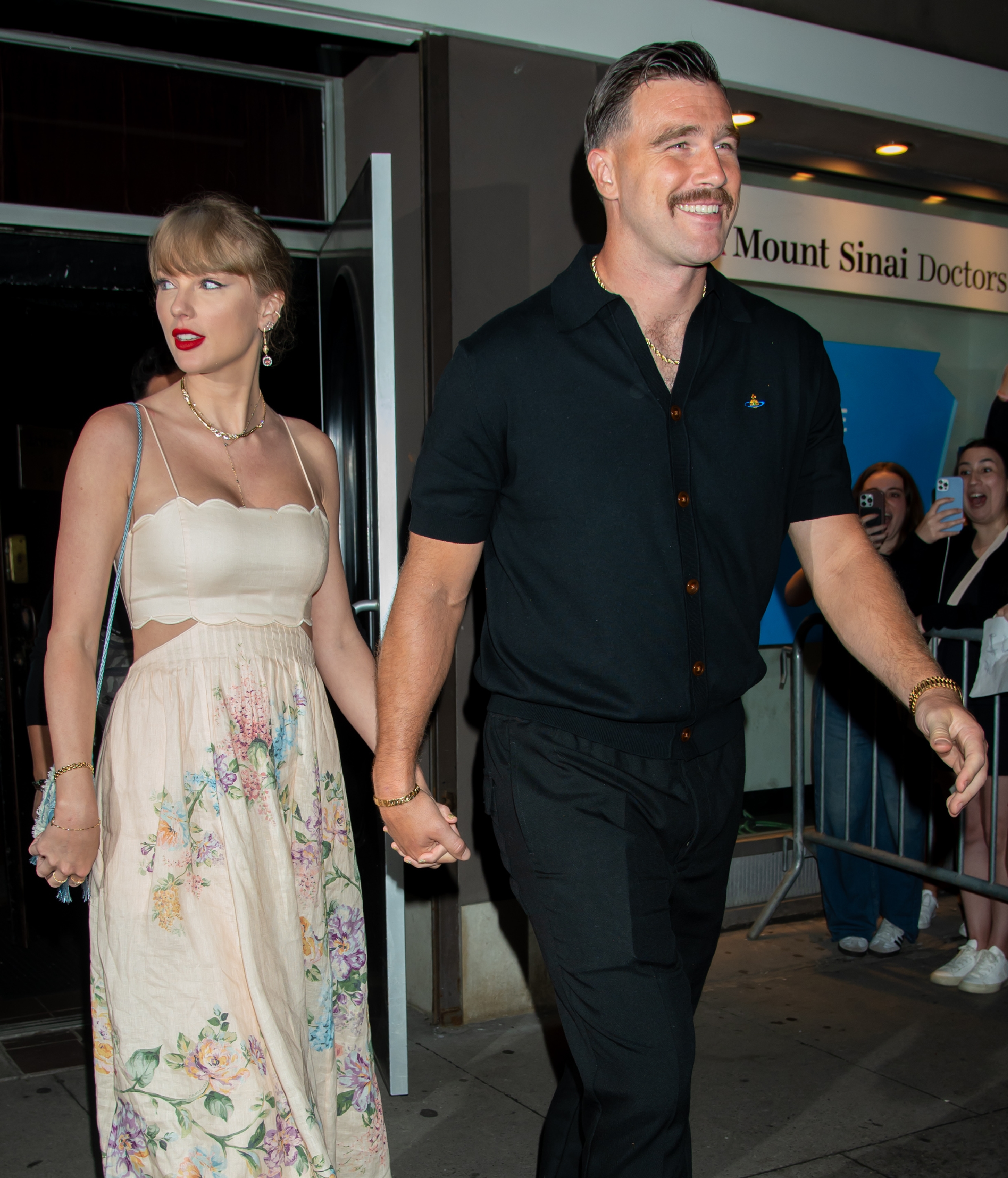 Taylor Swift and Travis Kelce hold hands during an outing in New York City. The couple later tied the knot at Madison Square Garden, where the arena was transformed with trees and ferns for their lavish ceremony. | Source: Getty Images
