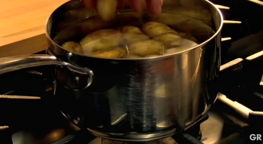 Gordon Ramsay places potatoes into a pot of cold water before turning on the heat, explaining that starting them this way allows them to cook evenly from the center out. The simple technique helps prevent the outsides from falling apart before the middle is fully tender. | Source: YouTube/ Gordon Ramsay