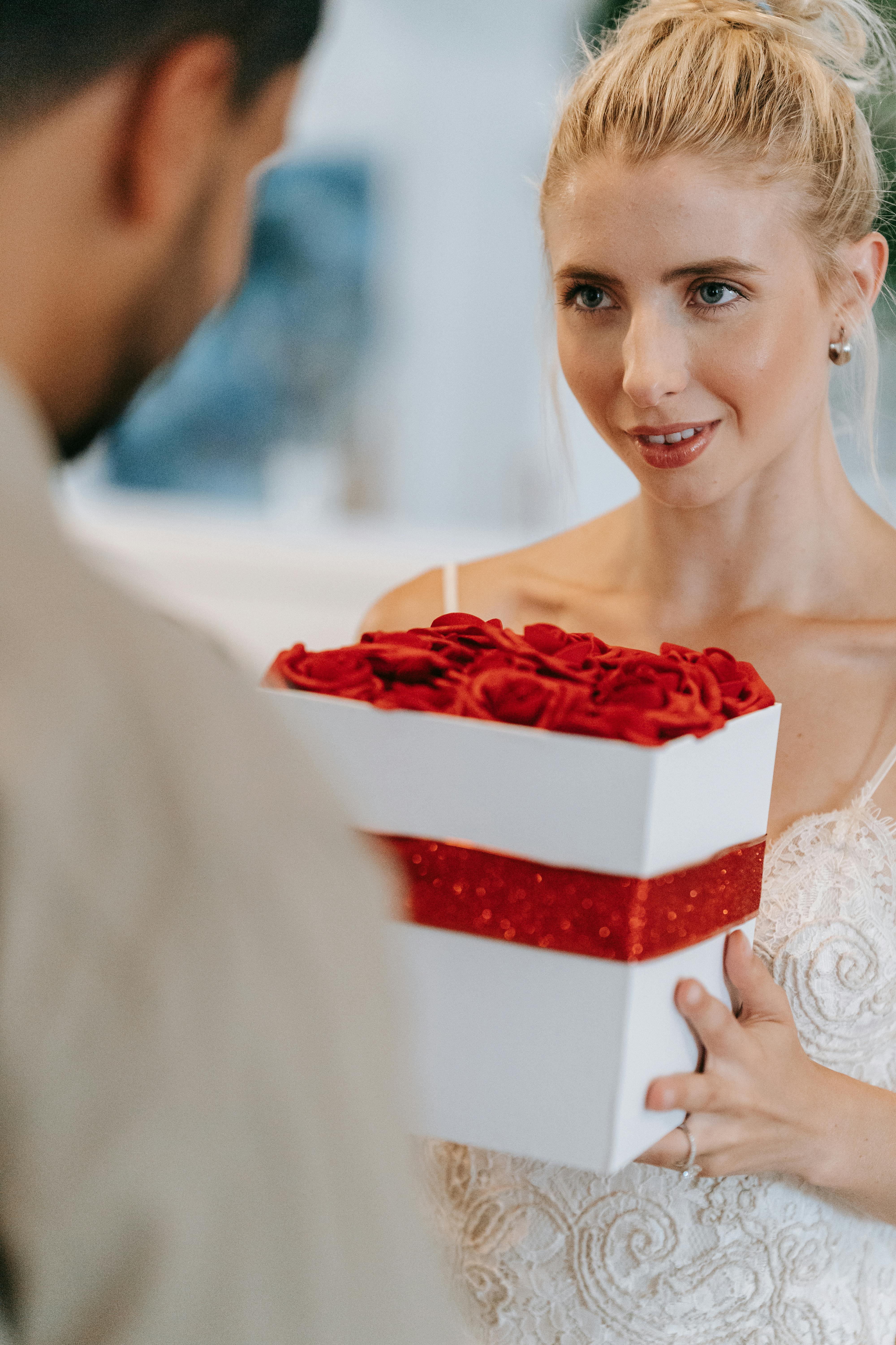 A sincere-looking woman giving a man a gift | Source: Pexels