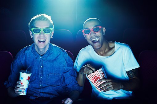 Photo of two friends at the cinema wearing 3D glasses | Photo: Getty Images