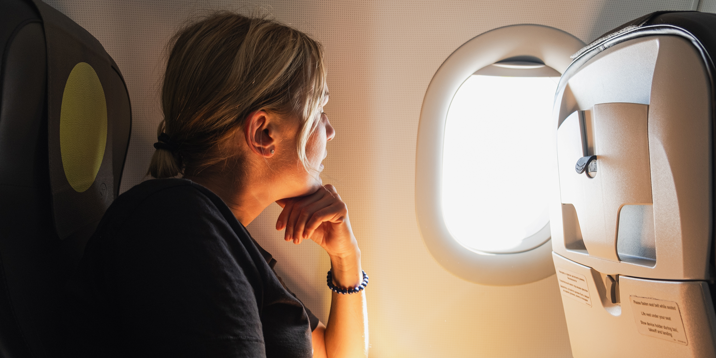 A woman sitting in an airplane | Source: Shutterstock