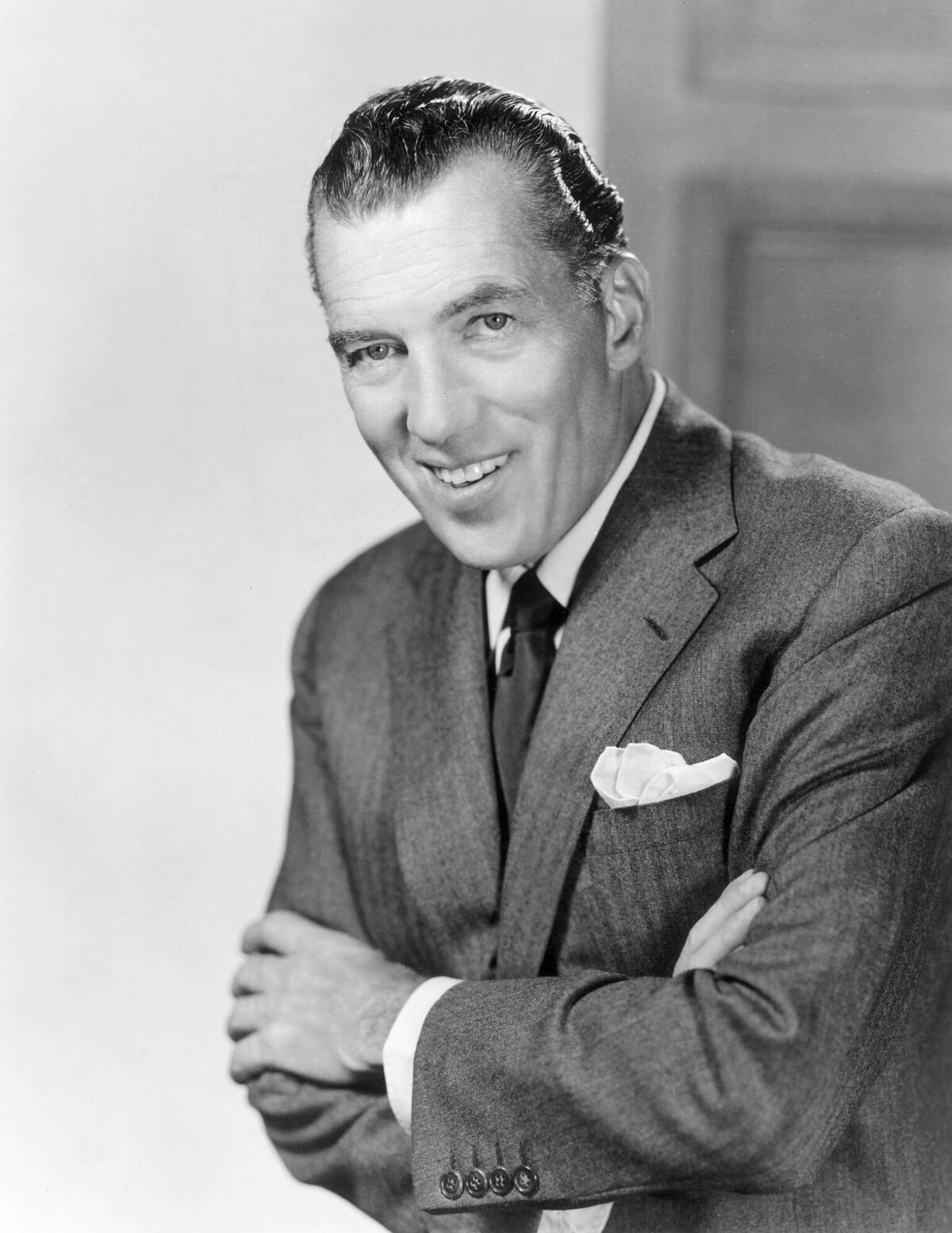  Promotional portrait of American television variety show host, Ed Sullivan smiling with his arms crossed | Source: Getty Images