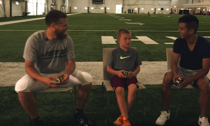 N.Y. Jets' Fitzpatrick & son during Rubik's Cube Showdown | Photo: YouTube/Wall Street Journal