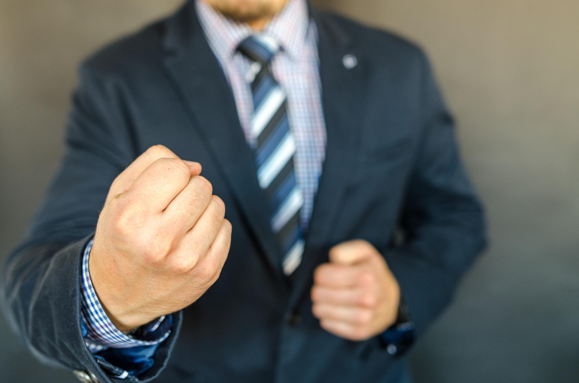 Un hombre vestido de traje amenazando con sus puños. | Foto: Pixabay