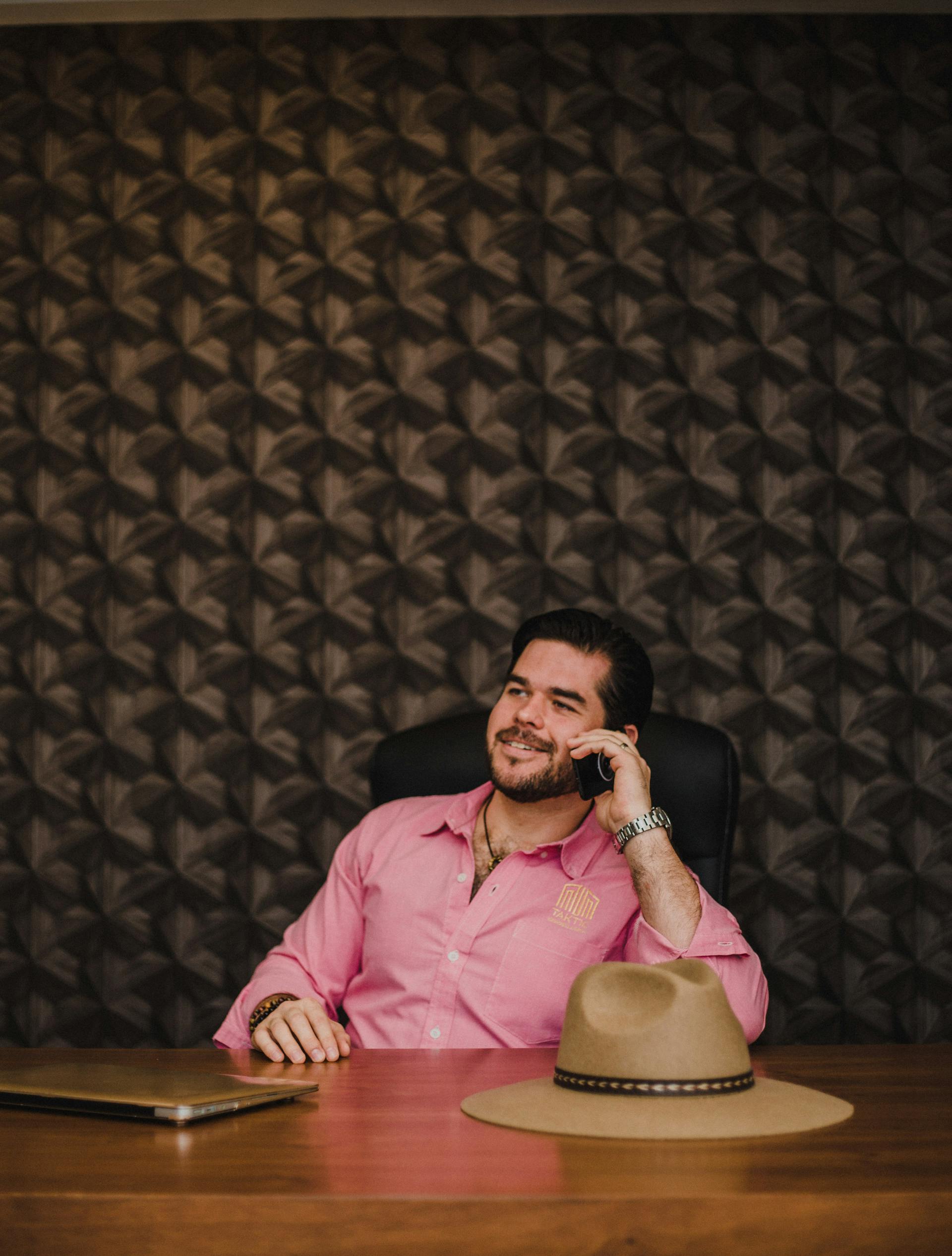 A smiling businessman talking on his phone | Source: Pexels
