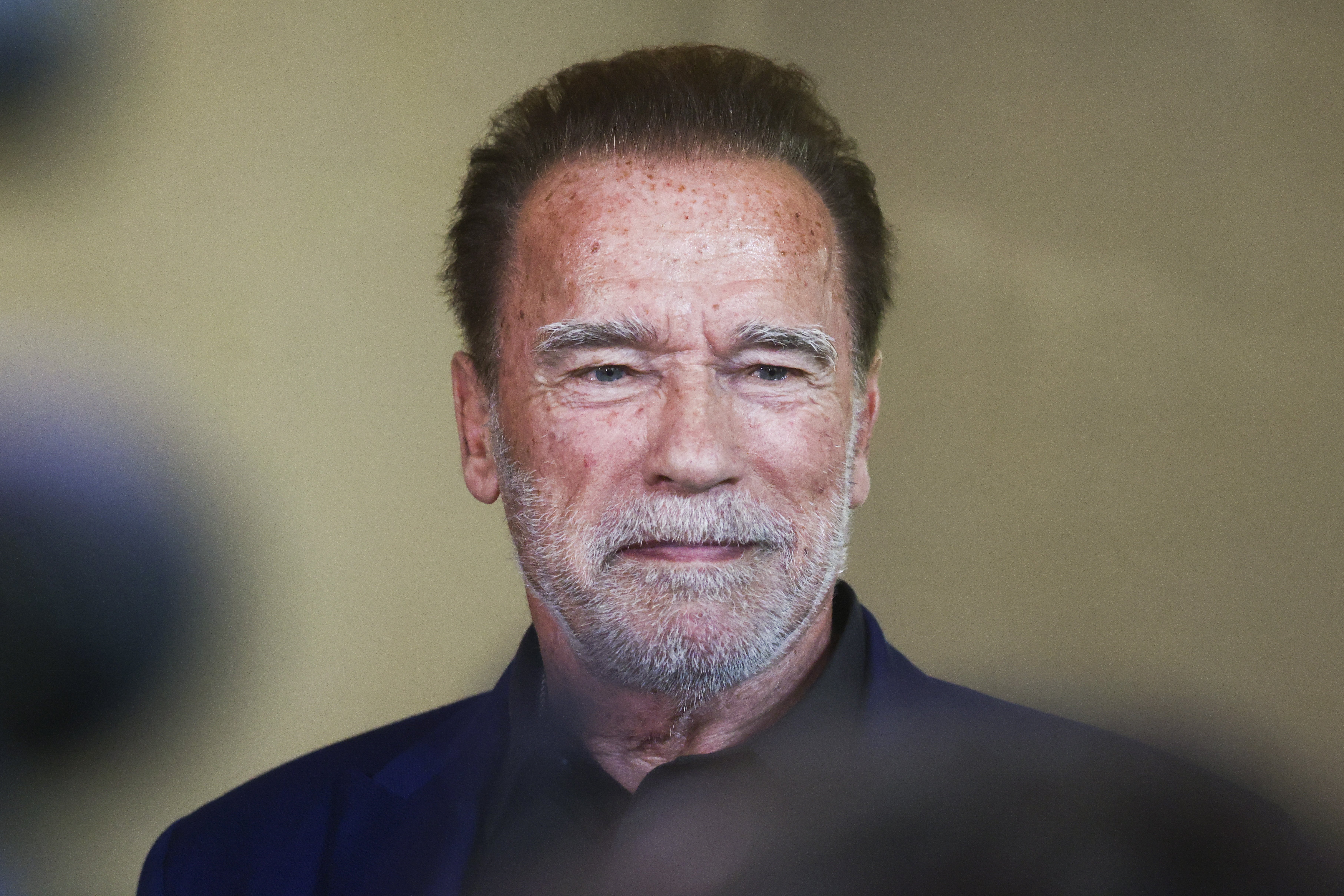 Arnold Schwarzenegger seen inside a former synagogue that is now home to the Auschwitz Jewish Center Foundation in Oswiecim, Poland, on September 28, 2022 | Source: Getty Images