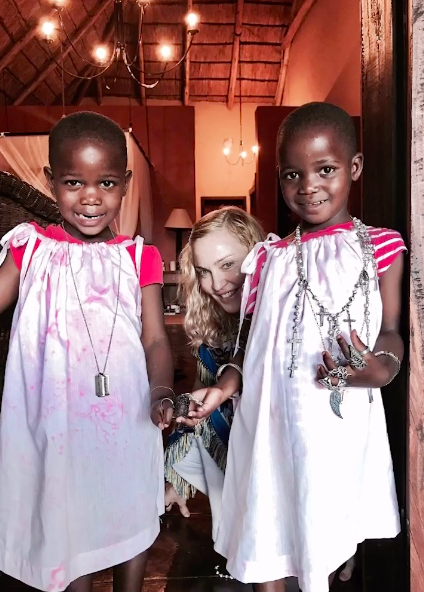 Madonna with her twin daughters, Estere and Stella, posing for a picture, posted on August 25, 2023 | Source: Instagram/madonna