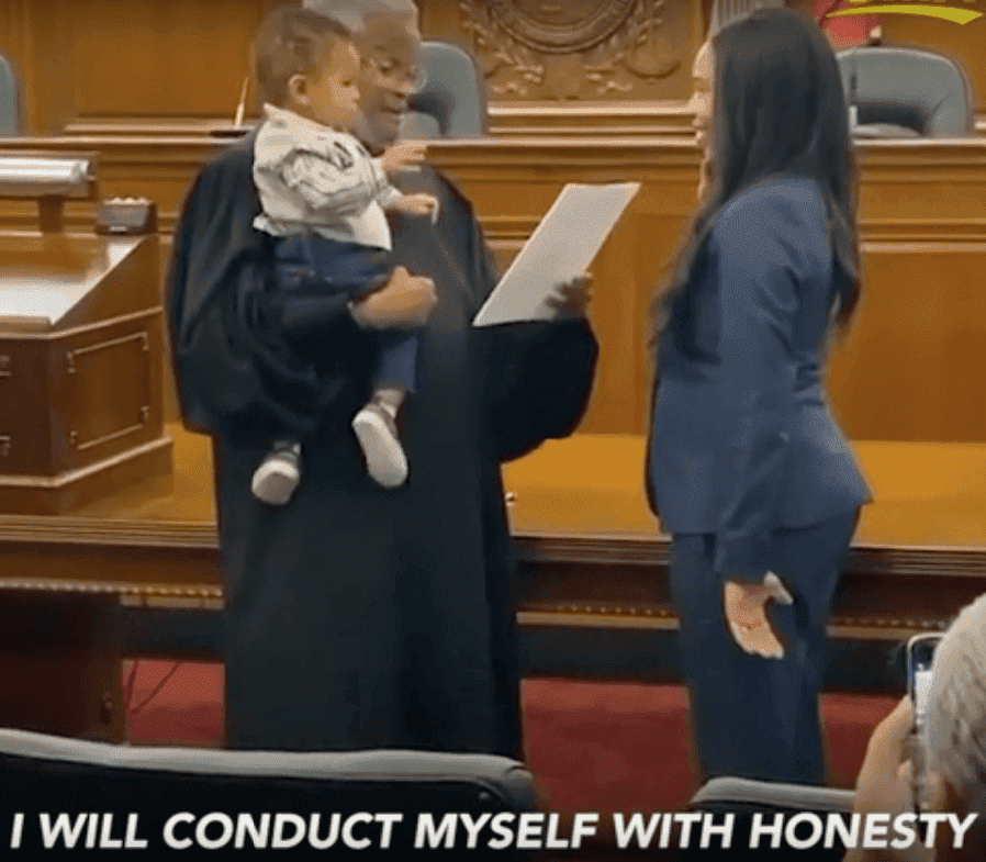 Judge Richard Dinkins holds one-year-old Beckham as the boy's mother, Julianna Lamar is sworn in. | Screenshot: YouTube/goodmorningamerica