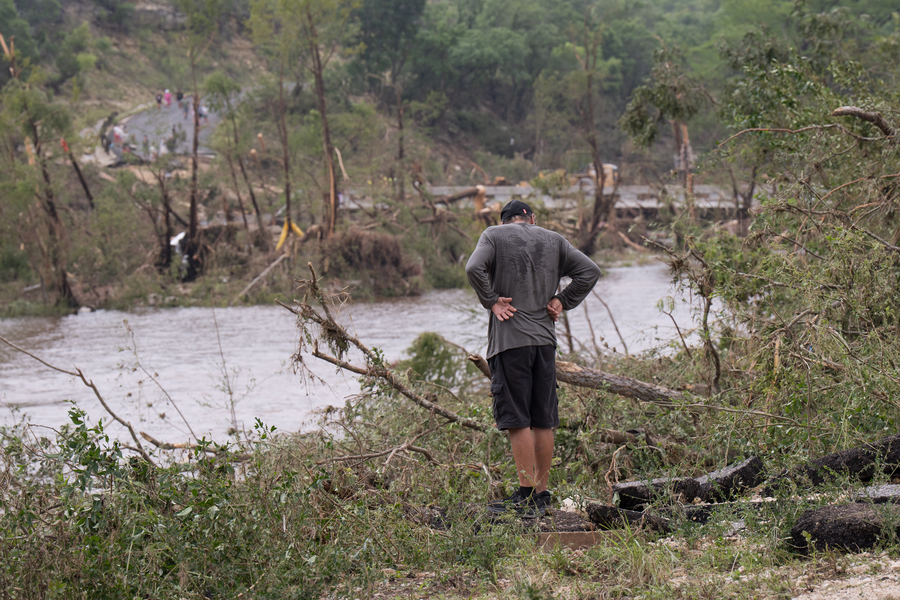 Local resident observes flood damage along the banks of the Guadalupe River near Ingram Warrior Stadium on July 5, 2025. | Source: Getty Images