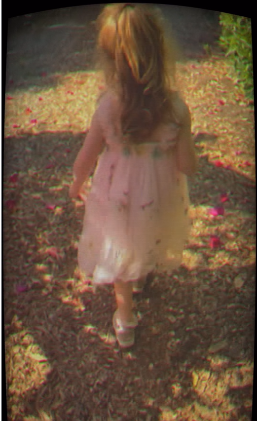 Princess Lilibet wanders through a petal-strewn garden in a flowing pink dress, creating a whimsical childhood scene. | Source: Instagram/meghan
