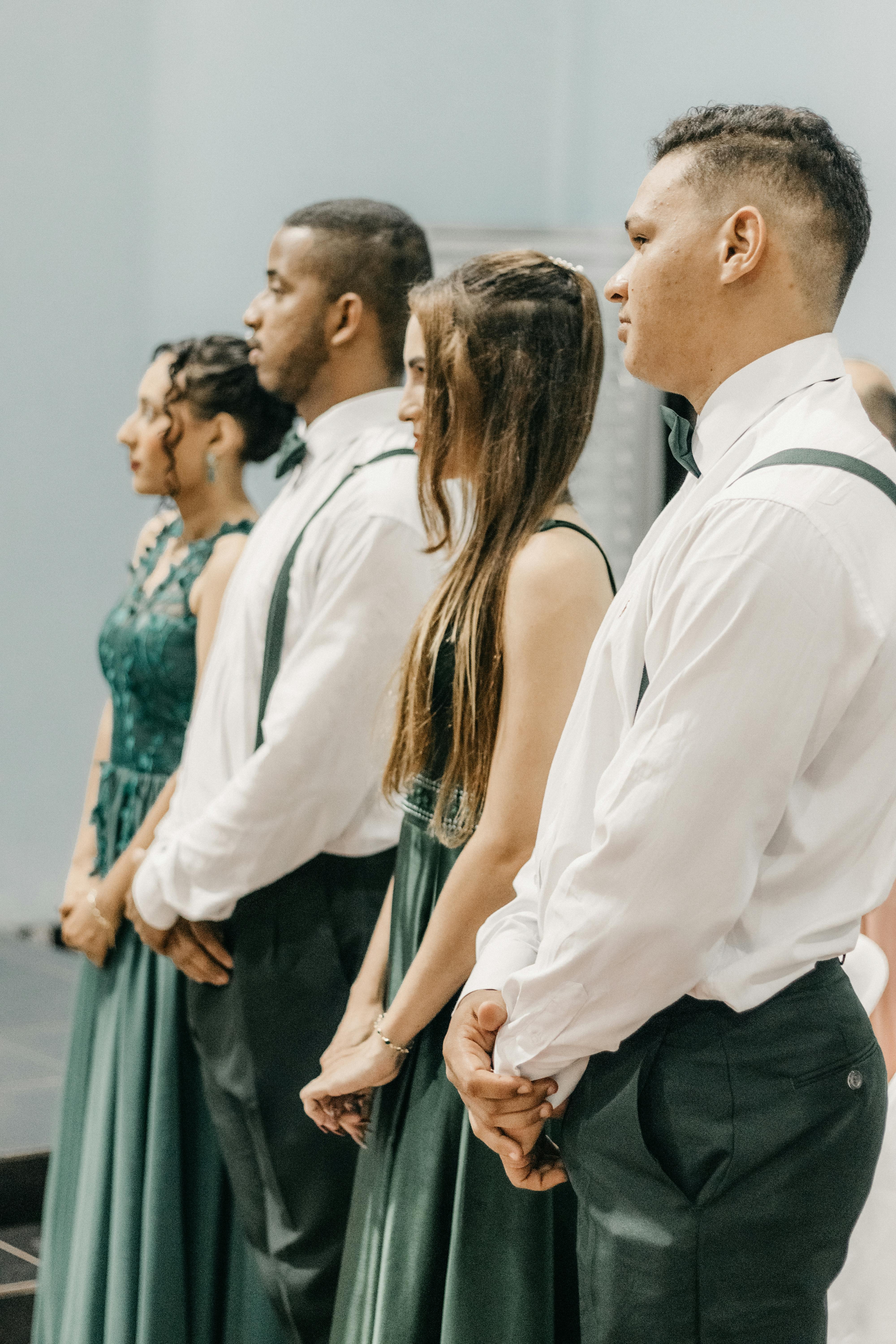Guests at a wedding stand up | Source: Pexels