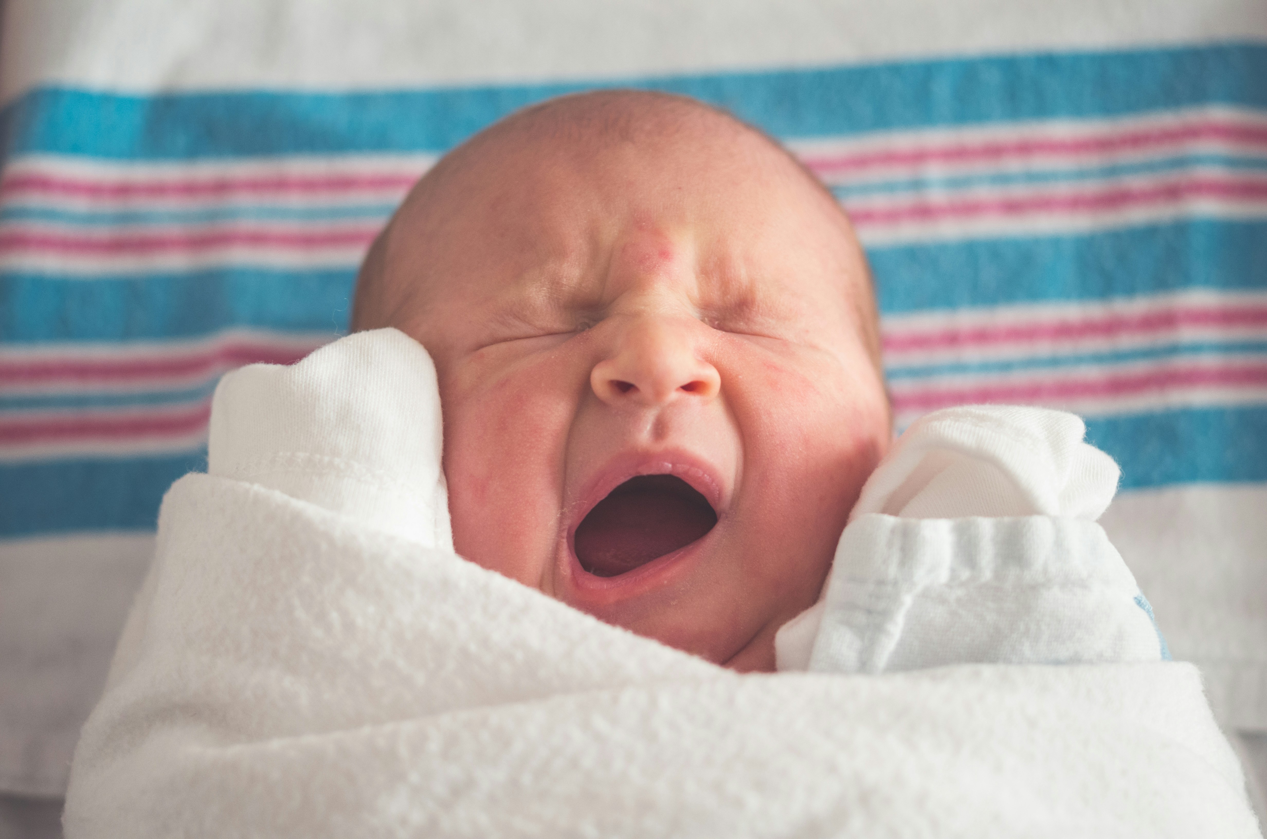 A cute little baby yawning | Source: Unsplash