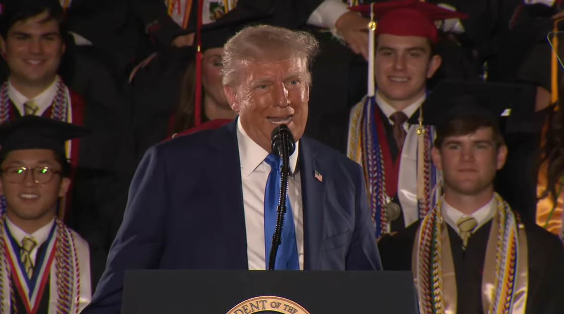 Reacting to the crowd's cheers, Donald Trump jokes that his mimicry might get him "in trouble" when he returns home, during the Alabama commencement speech | Source: YouTube/WhiteHouse