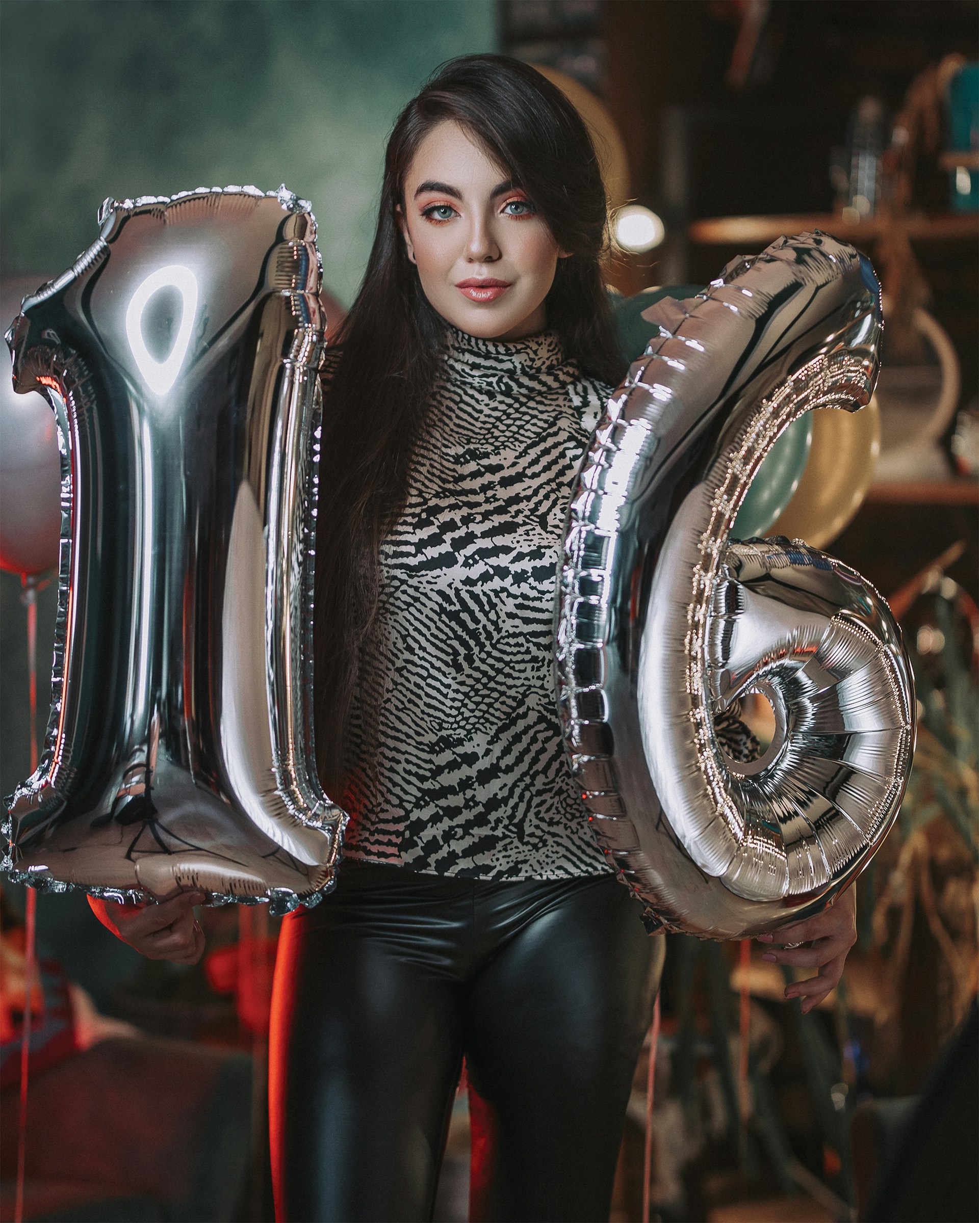 A girl holding silver balloons | Source: Unsplash
