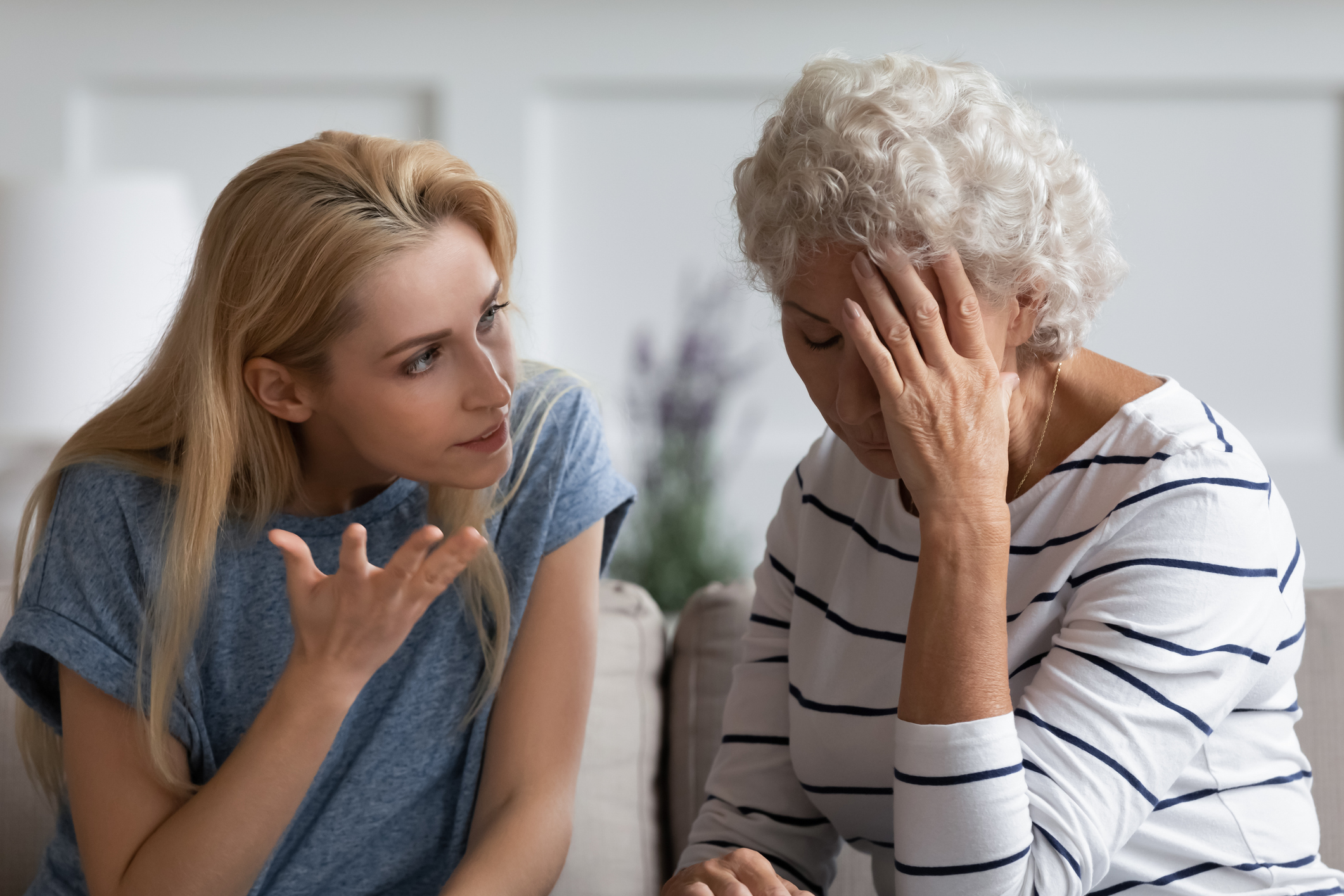 An angry woman arguing with her tired senior mother-in-law | Source: Getty Images