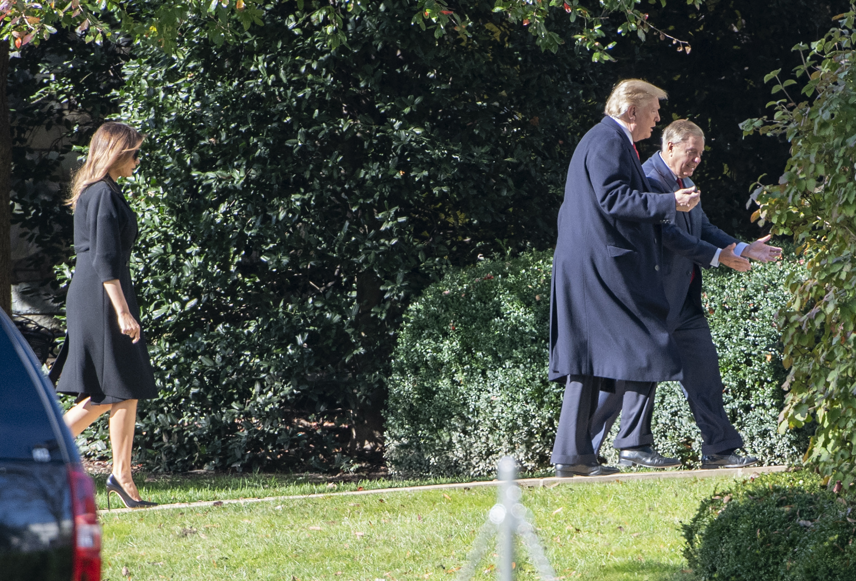 President Donald Trump and Senator Lindsey Graham walk across the White House grounds in November 2018. After Graham's death, Trump called him "like a member of the family" and ordered American flags to be flown at half-staff in his honor. | Source: Getty Images
