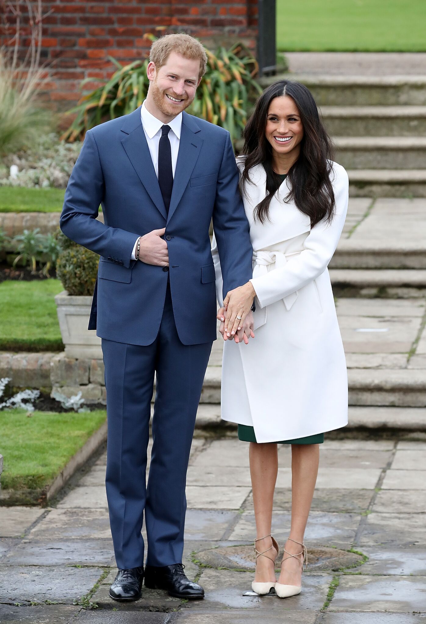  Prince Harry and actress Meghan Markle during an official photocall to announce their engagement at The Sunken Gardens at Kensington Palace | Getty Images